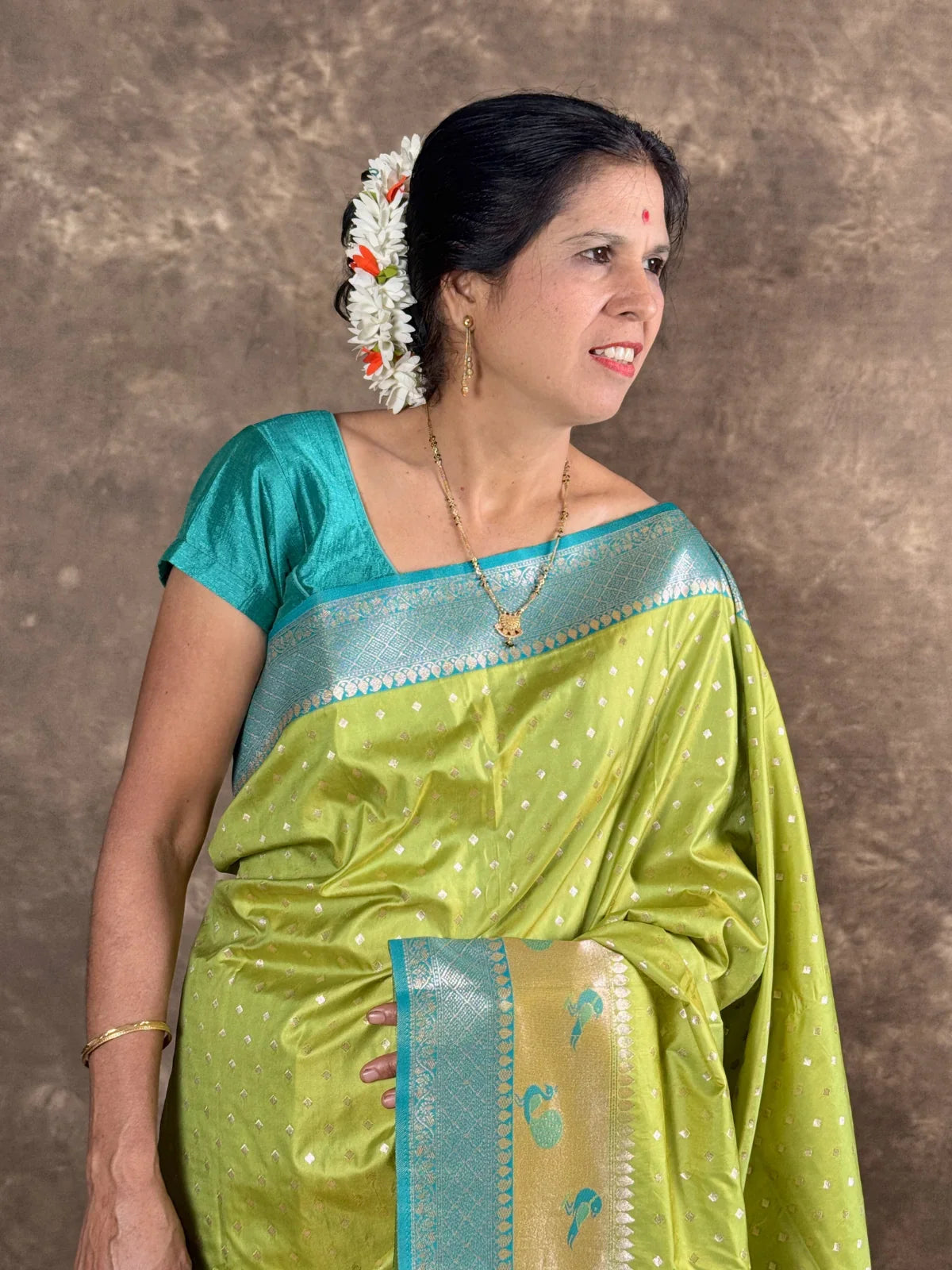 Tarani woven green silk saree upper body view styled with blue blouse