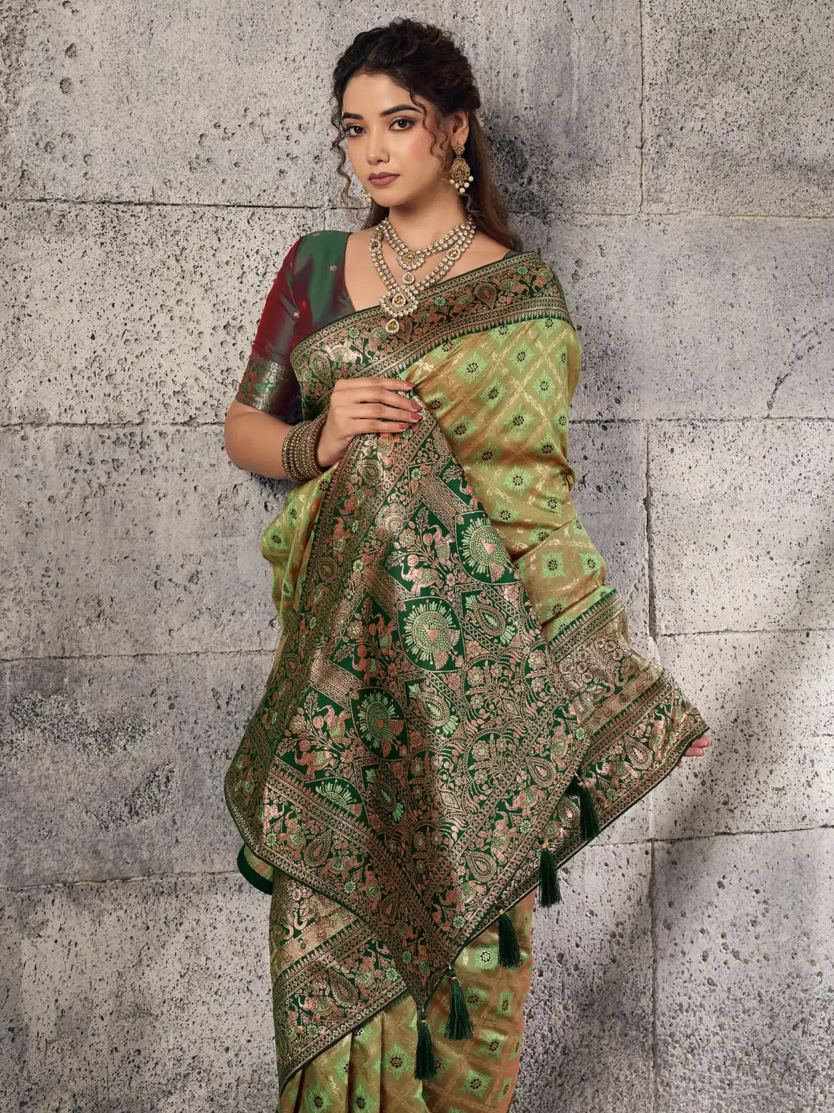 Tarani rich green Banarasi self embossed silk saree upper body view with woven pallu and contrast blouse