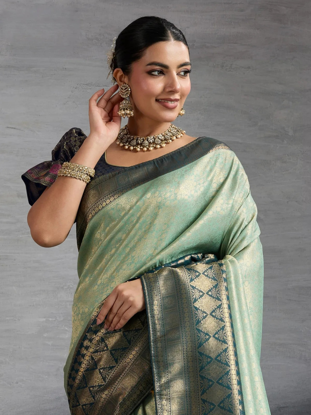 Tarani green silk saree upper view with brocade blouse and jewellery styling