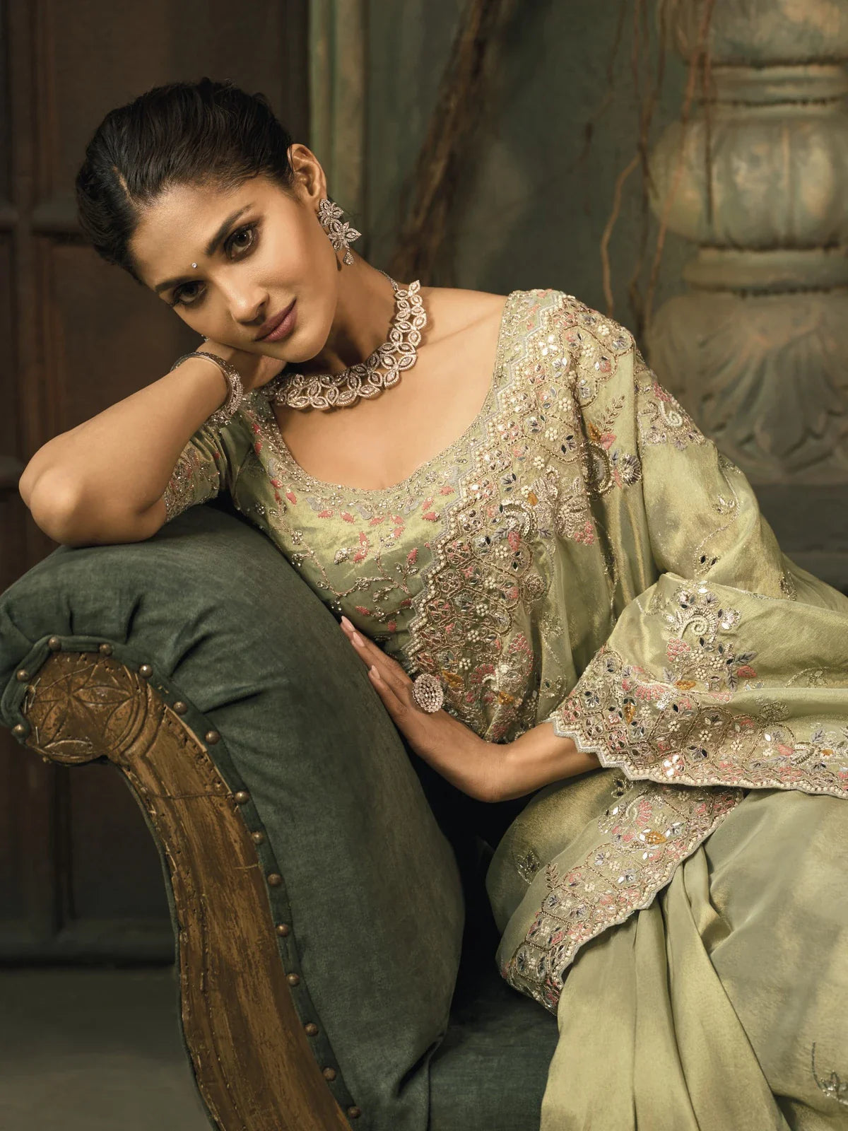 Tarani premium silk saree in green with detailed upper body view of mirror work blouse and neckline