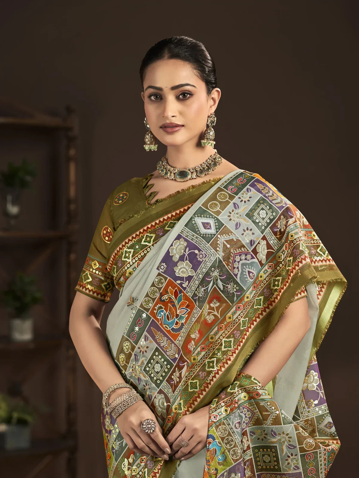 Tarani green crepe silk saree with multicolor patchwork pallu and close-up of blouse design