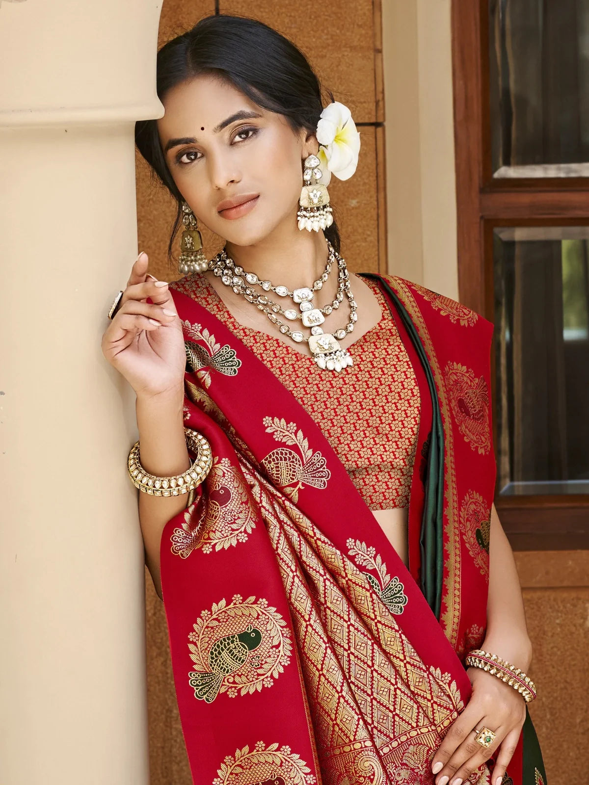 Tarani rich zari woven silk saree with red contrast pallu shown in upper body view for traditional occasions