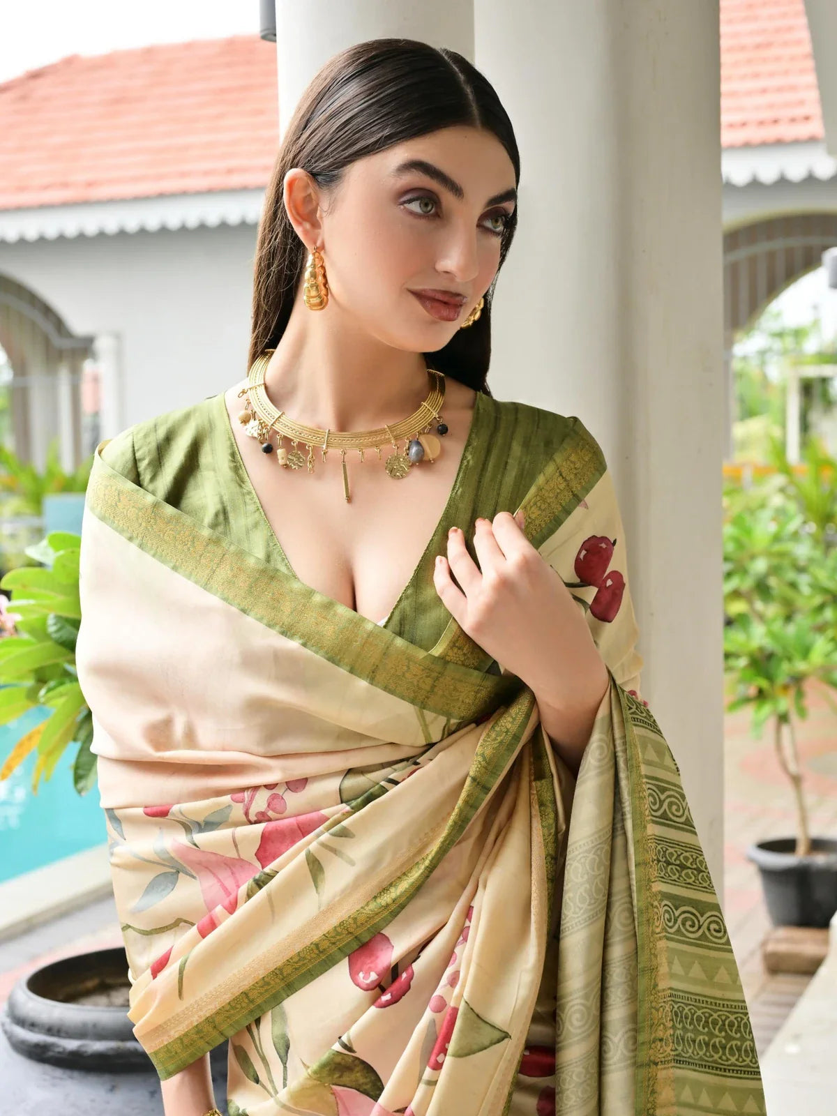 Tarani cream and green printed satin silk saree upper body with elegant neckline and jewelry