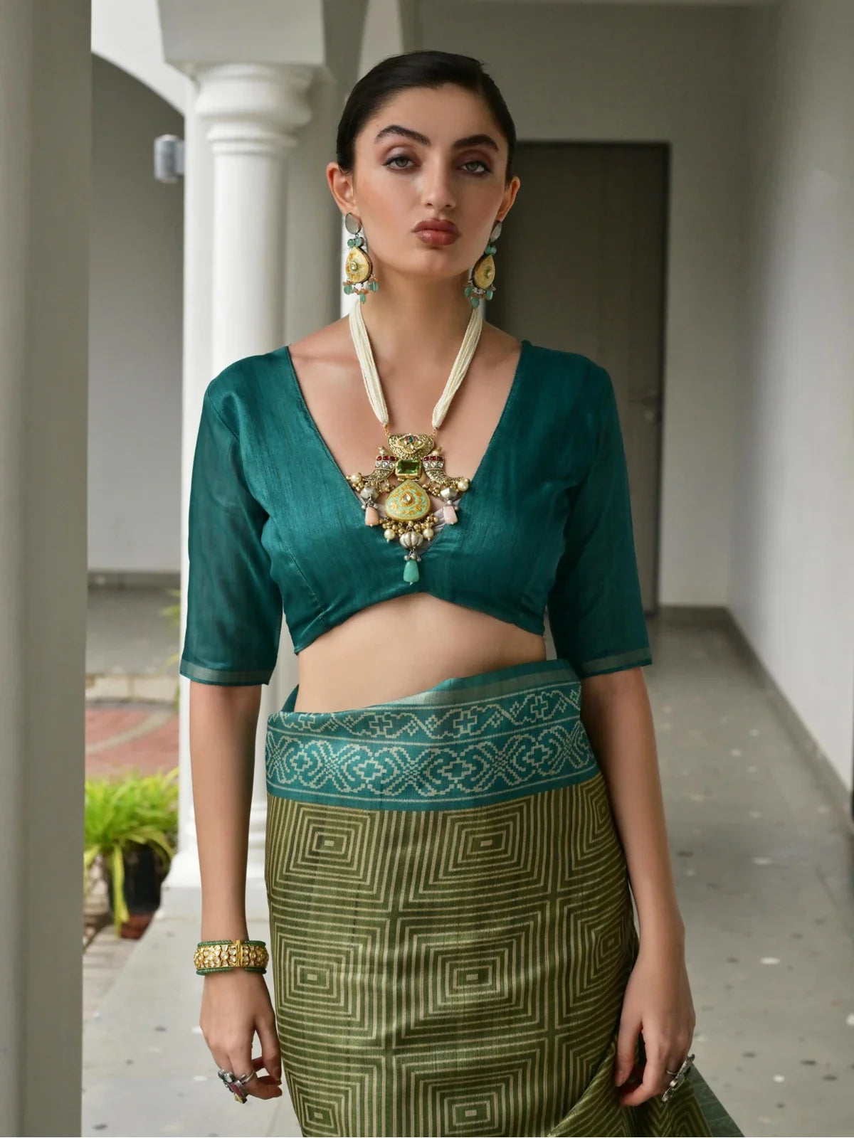 Tarani tussar silk saree with deep green blouse and front neckline close-up