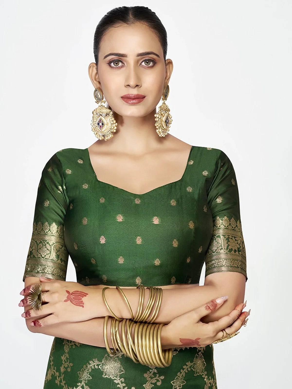 Tarani green silk saree blouse close-up with golden motifs and square neckline