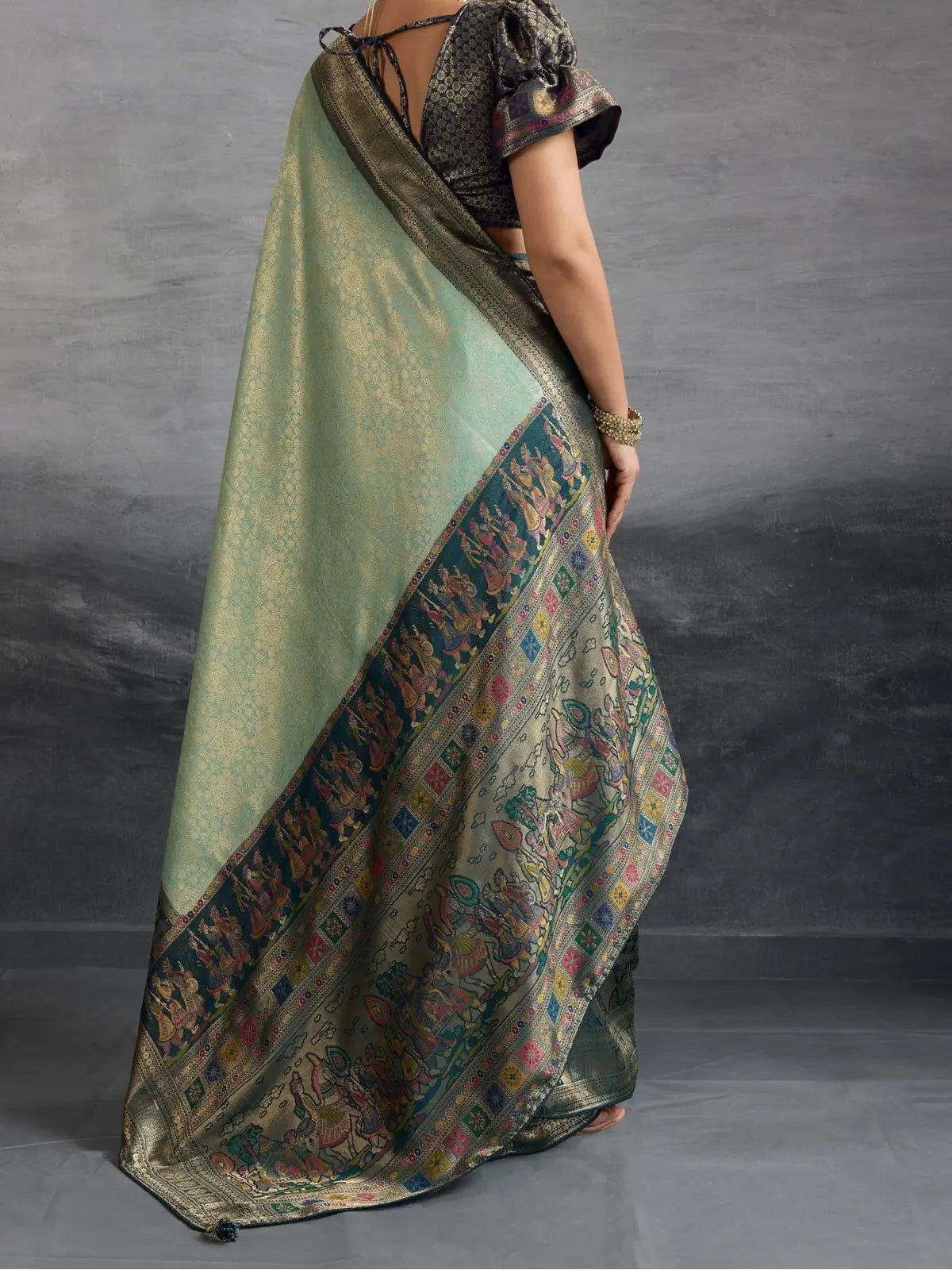 Tarani elegant soft green silk saree with zari border and pallu back view