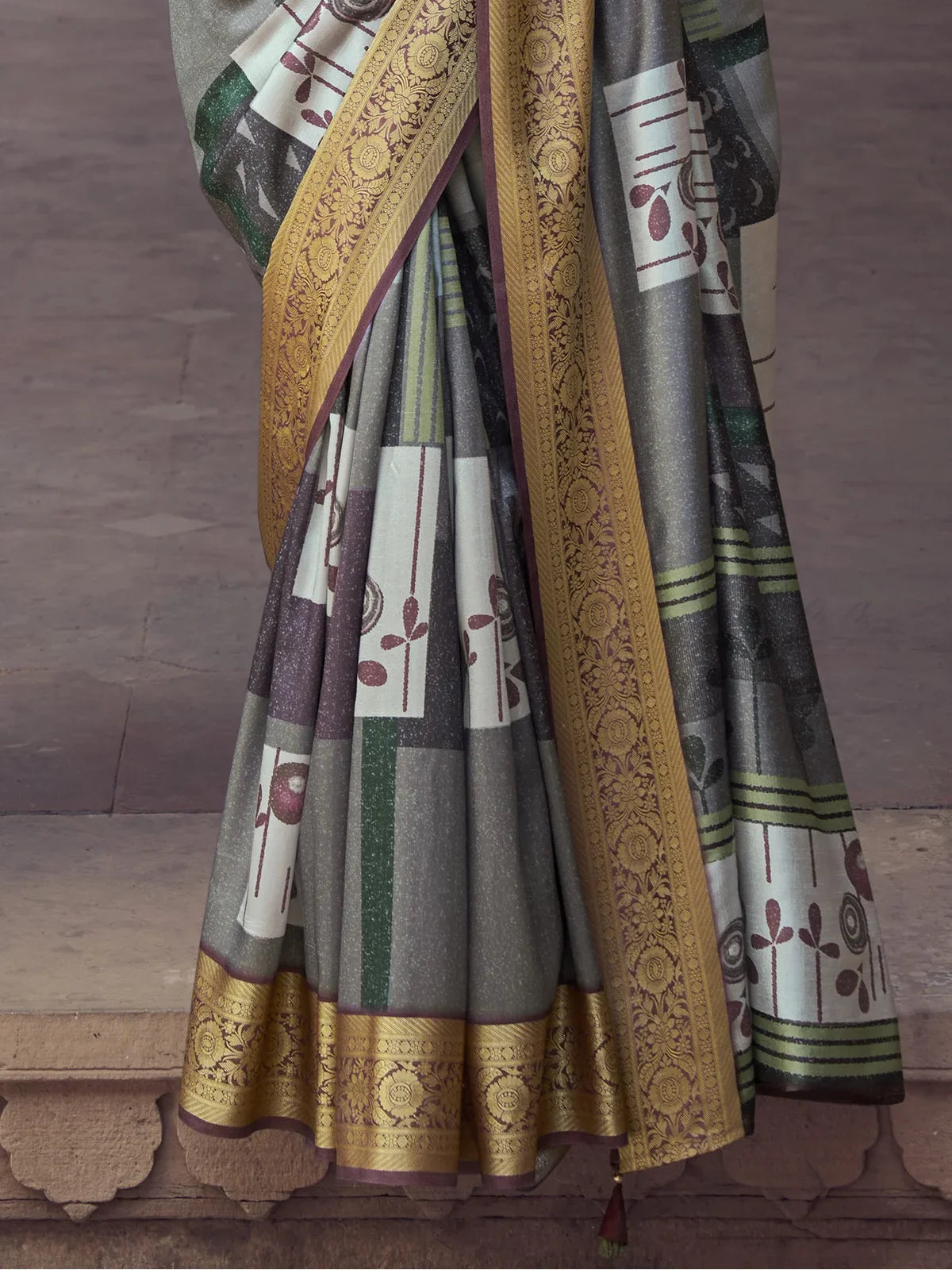Tarani closeup view of grey silk saree fabric with embroidery and tassel detail