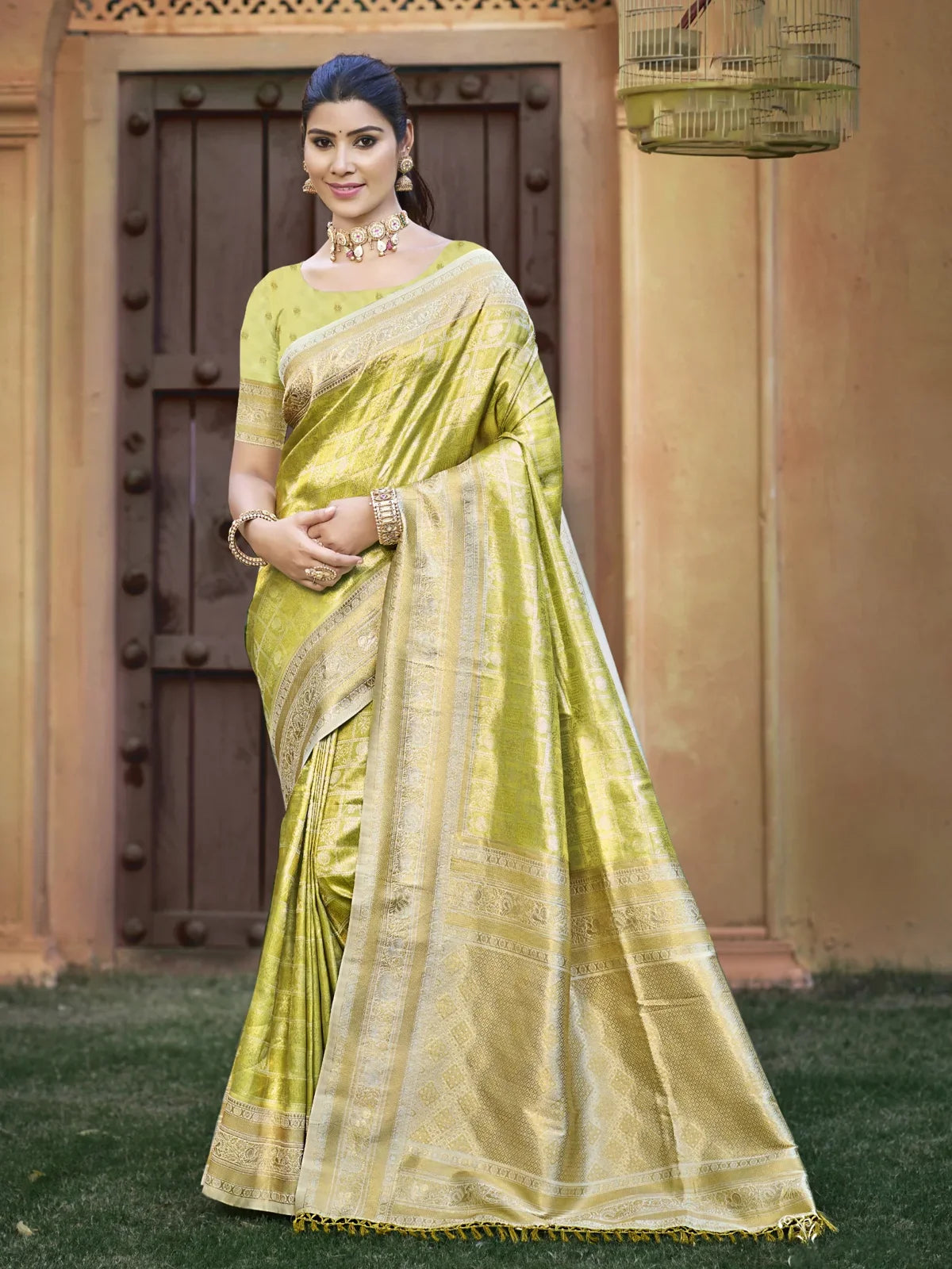 Tarani light green Kanjivaram silk saree with golden zari border and matching blouse for festive wear