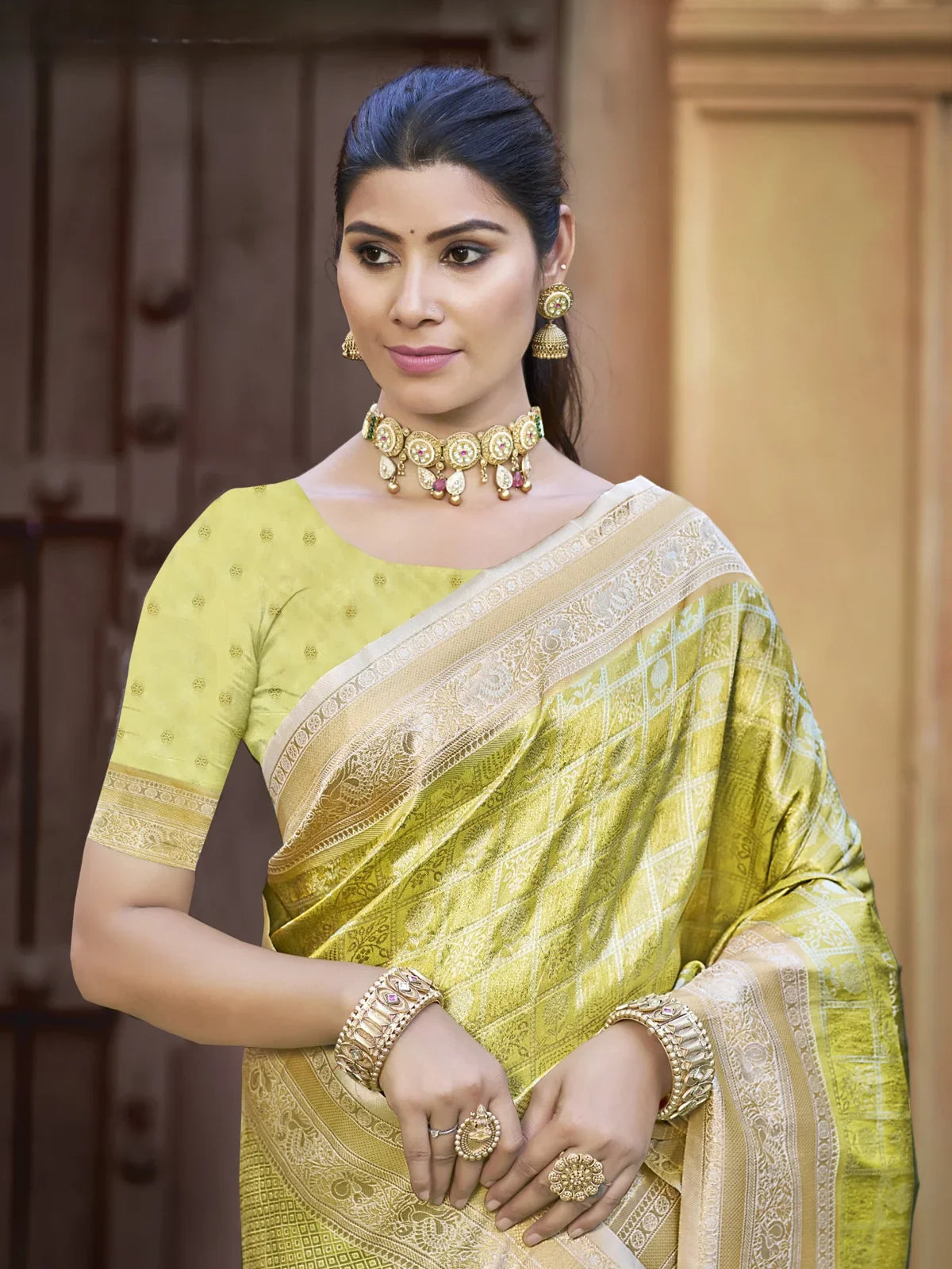 Tarani upper body view of light green Kanjivaram silk saree with intricate zari work and festive jewelry