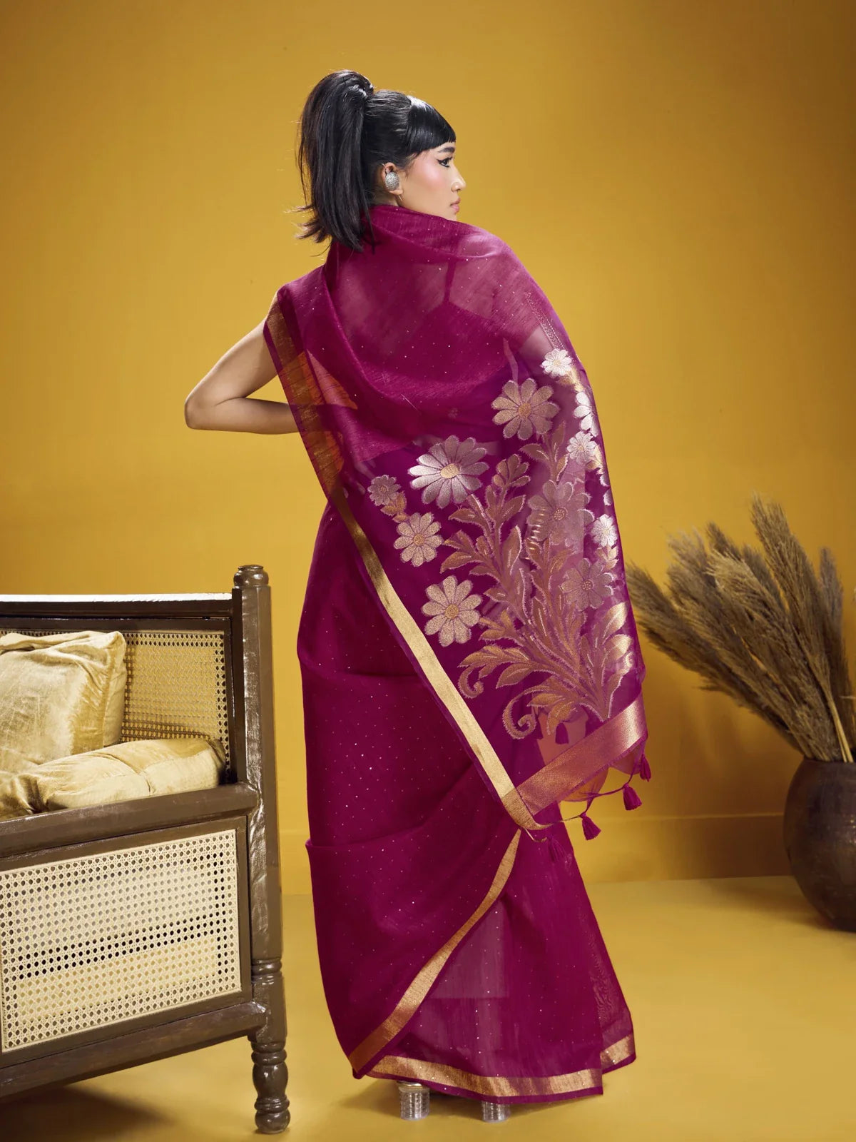 Tarani back pose of magenta munga silk saree with transparent pallu and flower embroidery