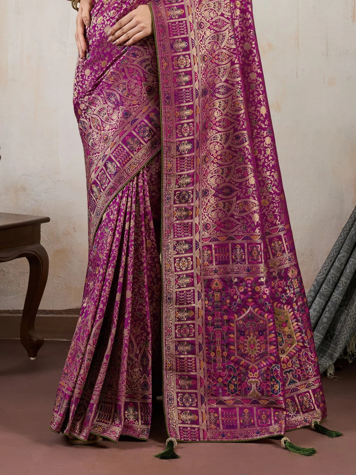 Tarani magenta silk saree pallu view showing intricate Meenakari weaving and tassel finish