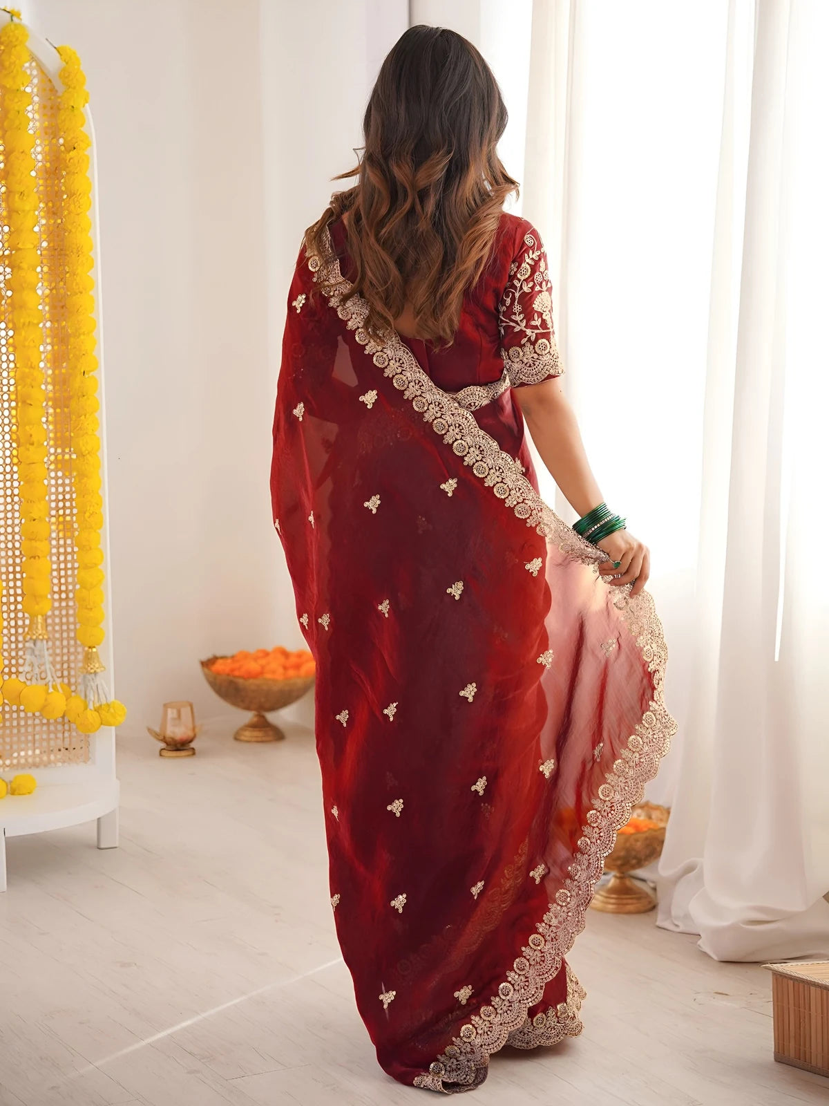 Tarani Mrunmayi maroon saree back view with elegant drape and embroidered border