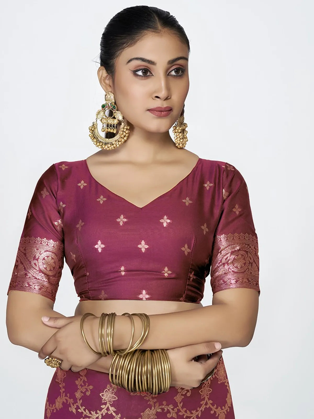 Tarani maroon silk saree upper body closeup showing blouse and earrings