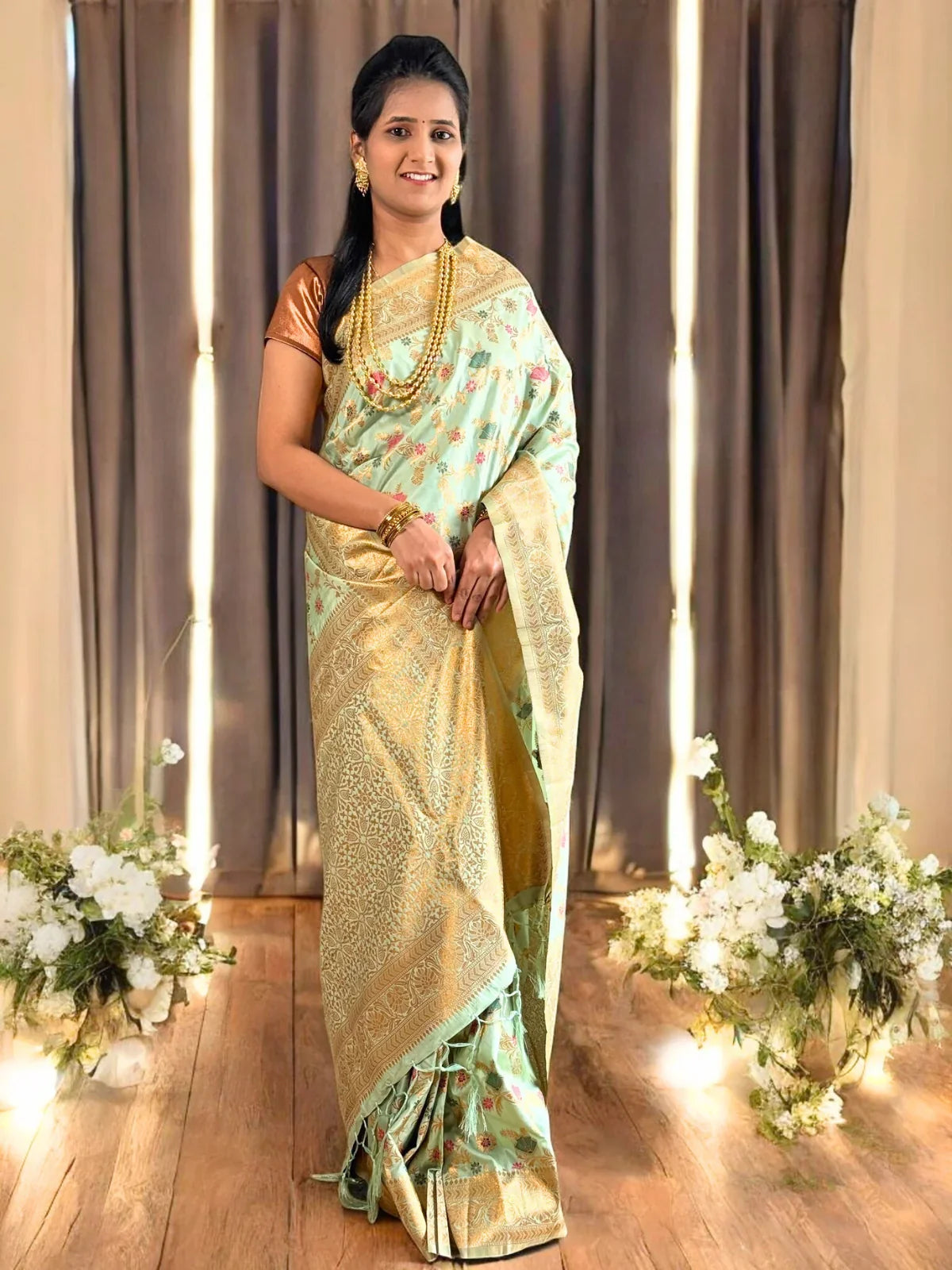 Tarani premium green silk saree full view with golden zari border and floral weave