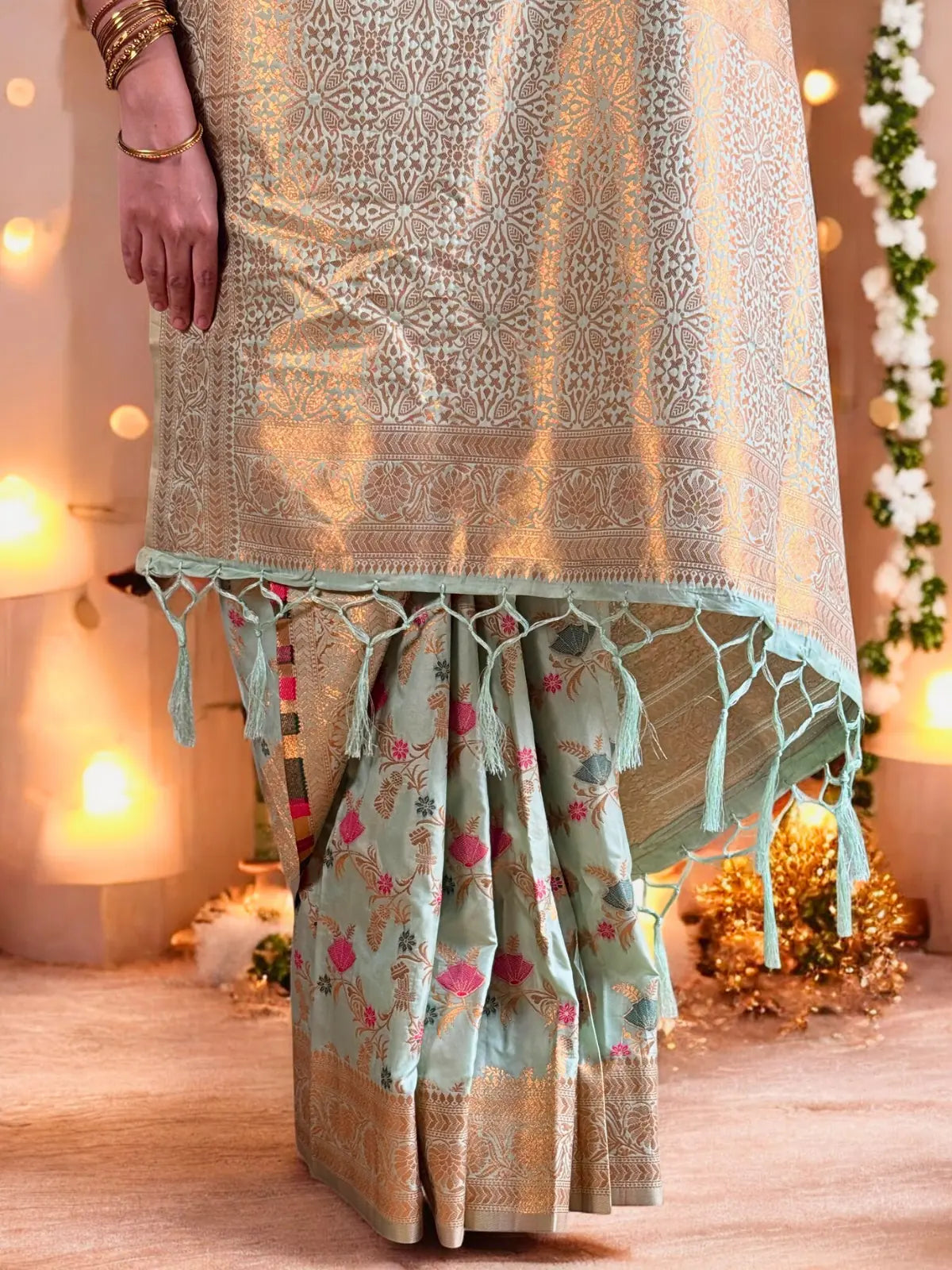 Tarani festive green silk saree pallu view highlighting golden zari work