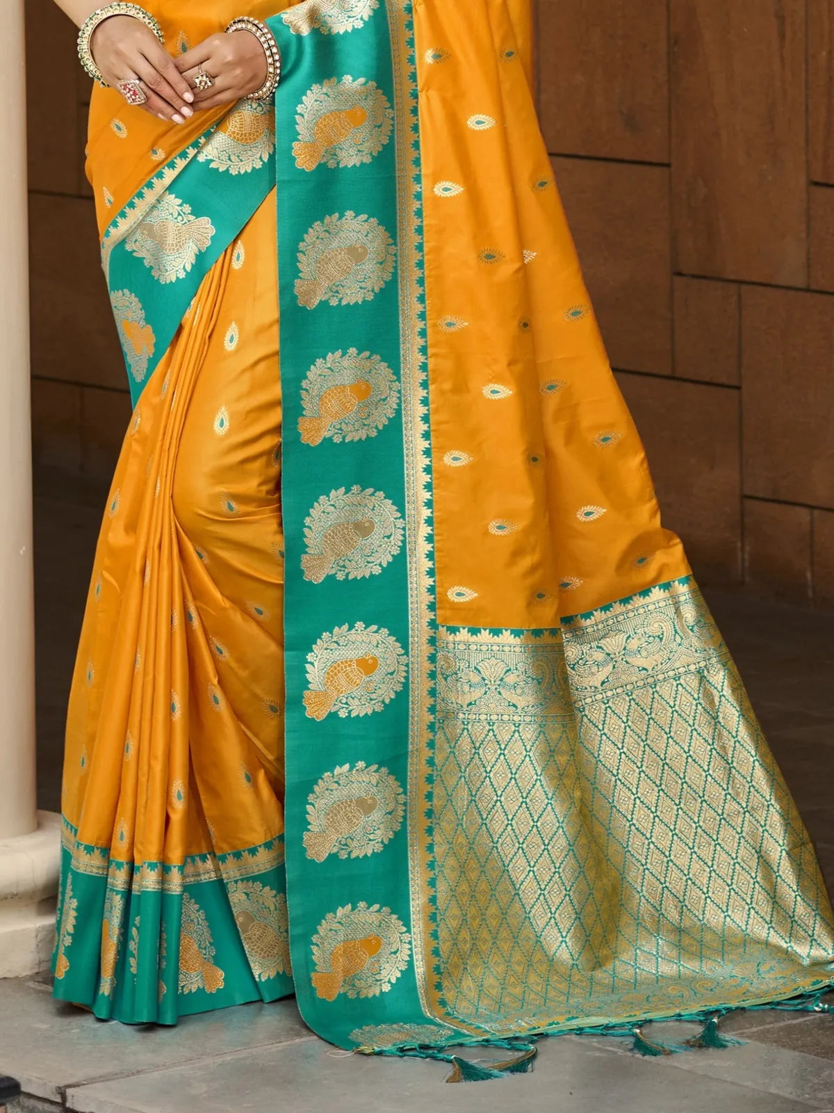 Tarani mustard silk saree pallu view with rich zari weaving border and traditional motifs