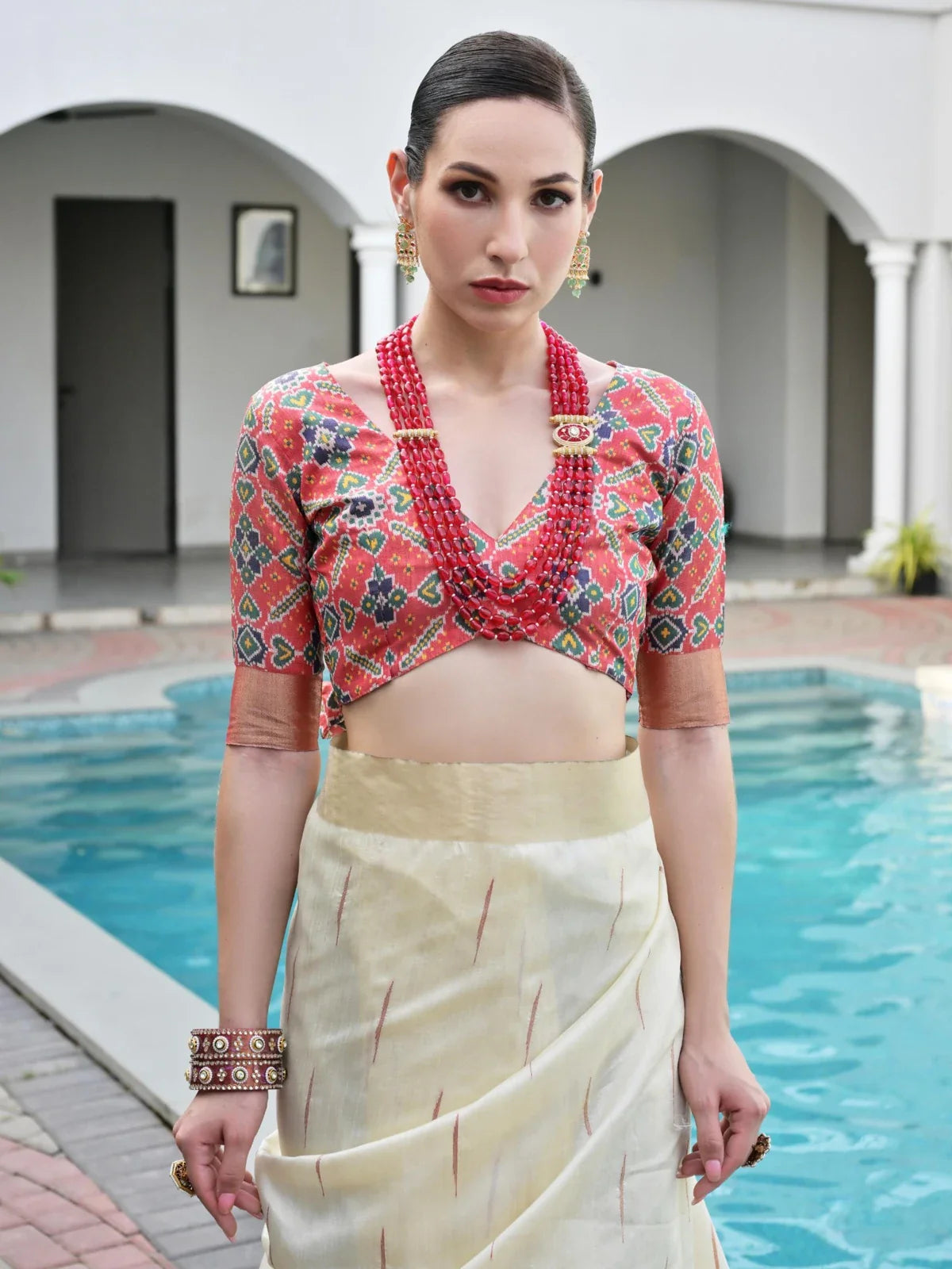 Tarani festive raw silk saree upper body closeup showing contrast red ikkat blouse design