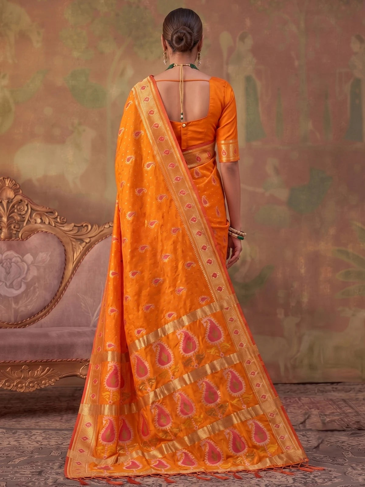 Tarani orange silk saree back view showing blouse design and zari weaving