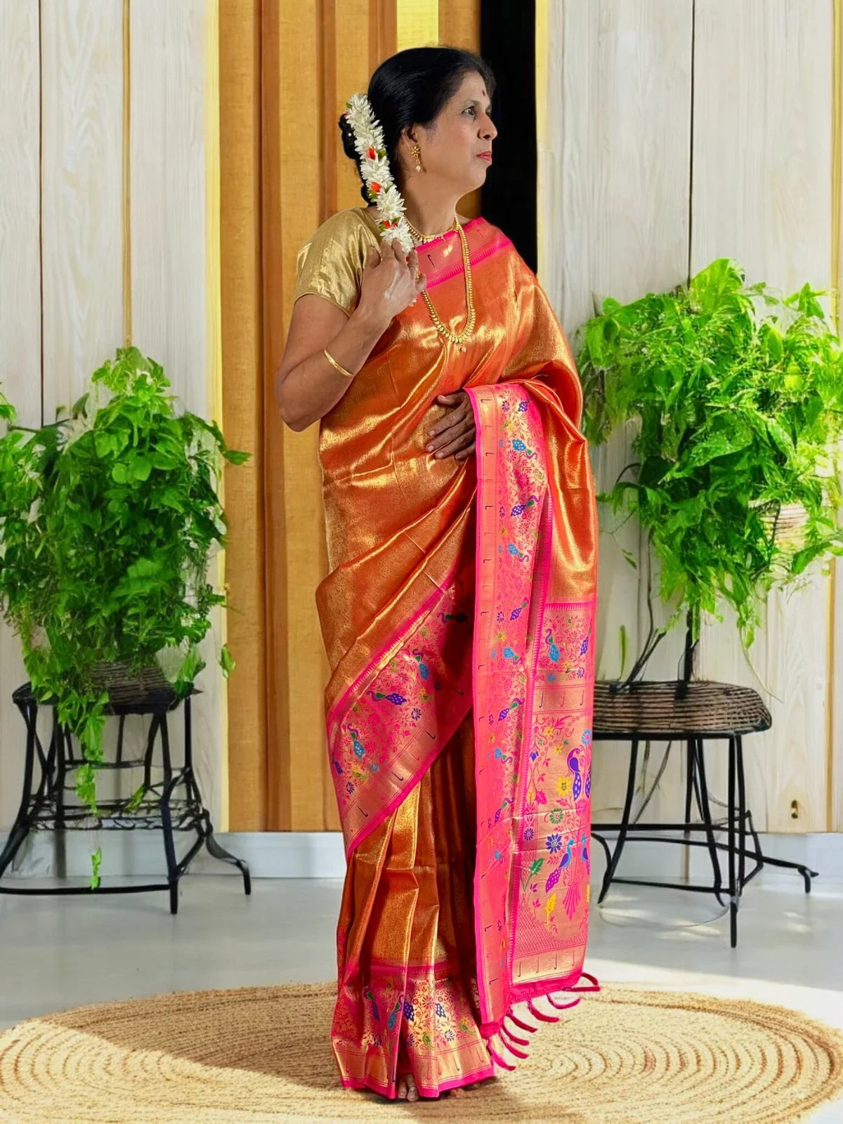 Tarani orange silk saree side view showing festive woven details