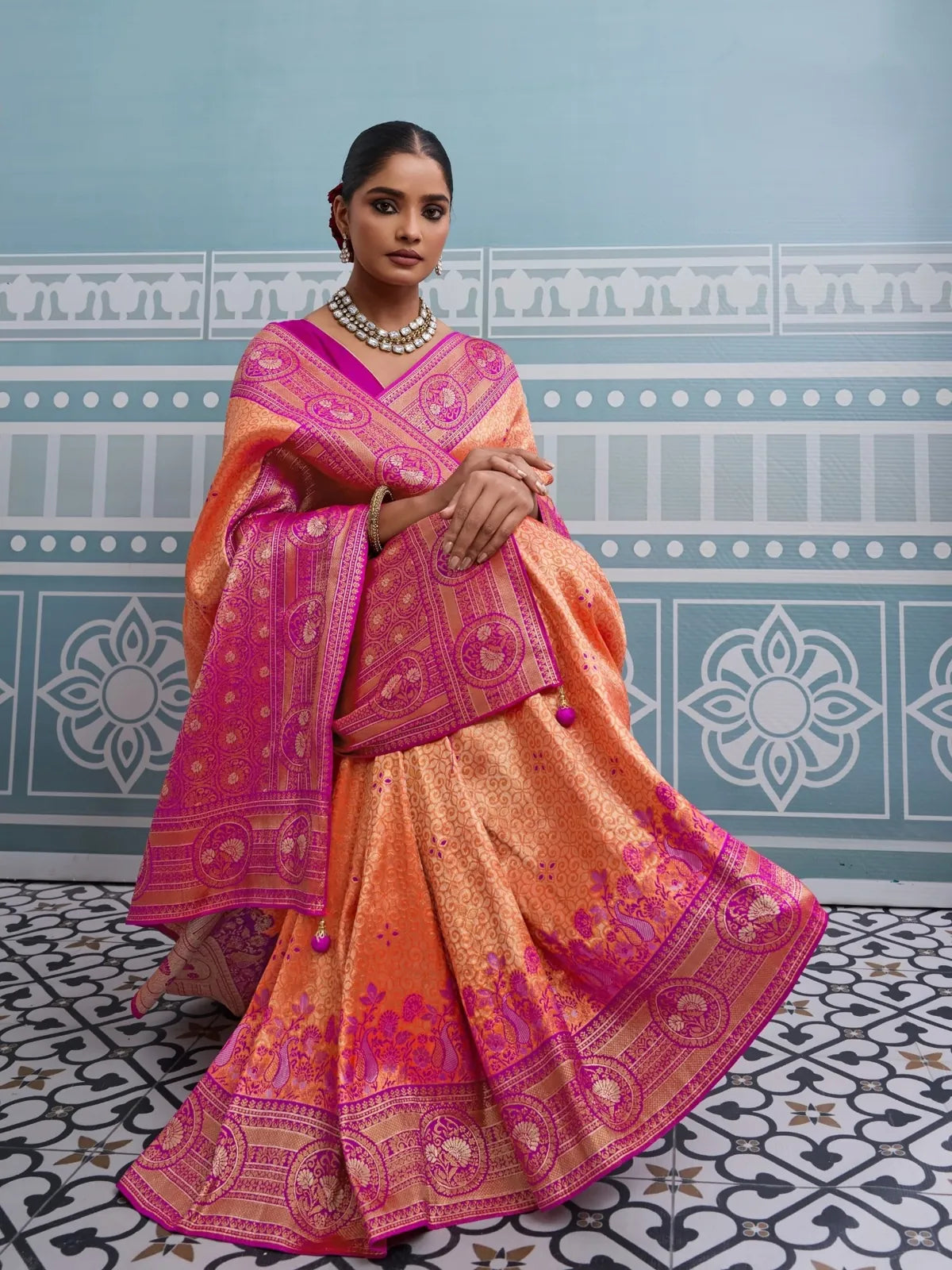 Tarani designer orange silk saree with zari thread work and meenakari weaving front pose