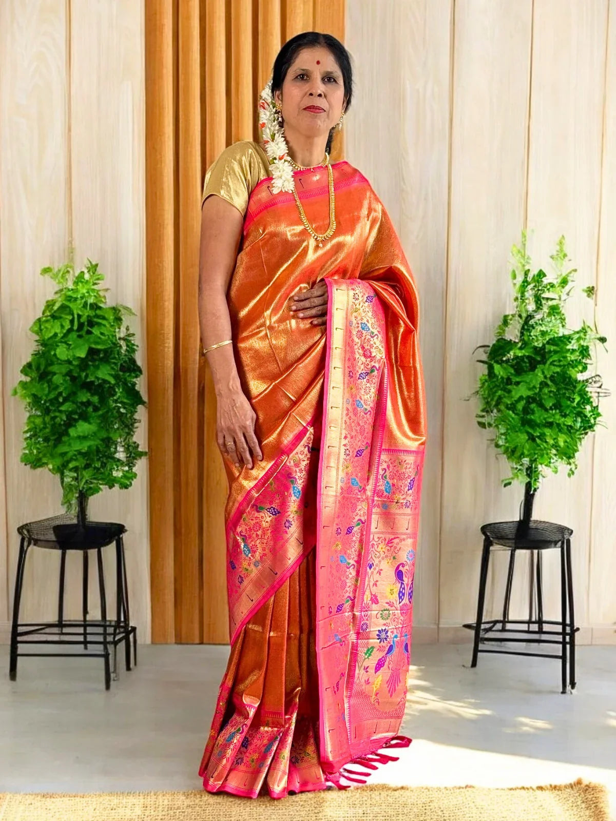 Tarani premium orange silk saree full view with vibrant pink pallu for festive occasions