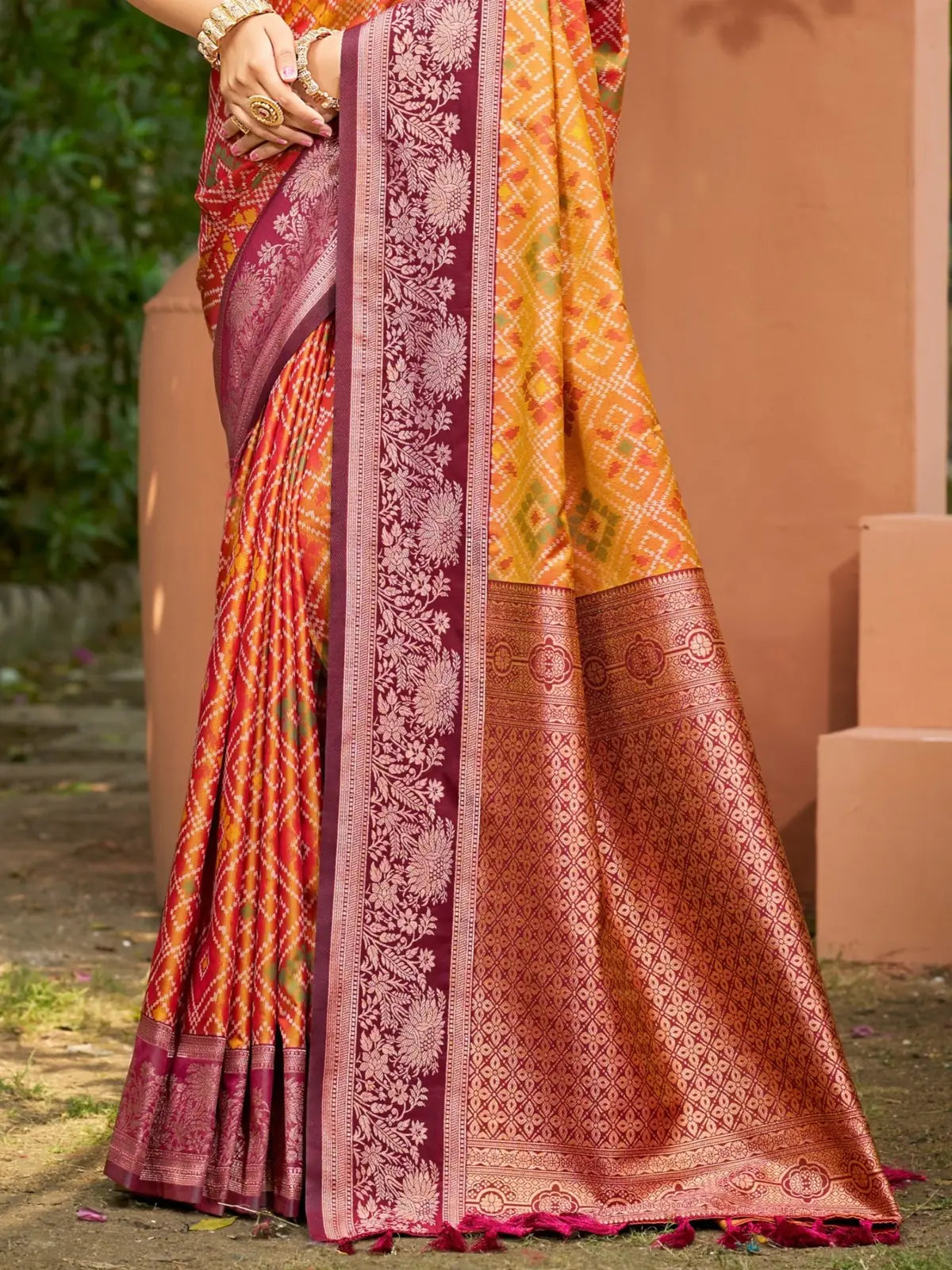 Tarani soft silk orange saree pallu view with intricate maroon weaving border detailing