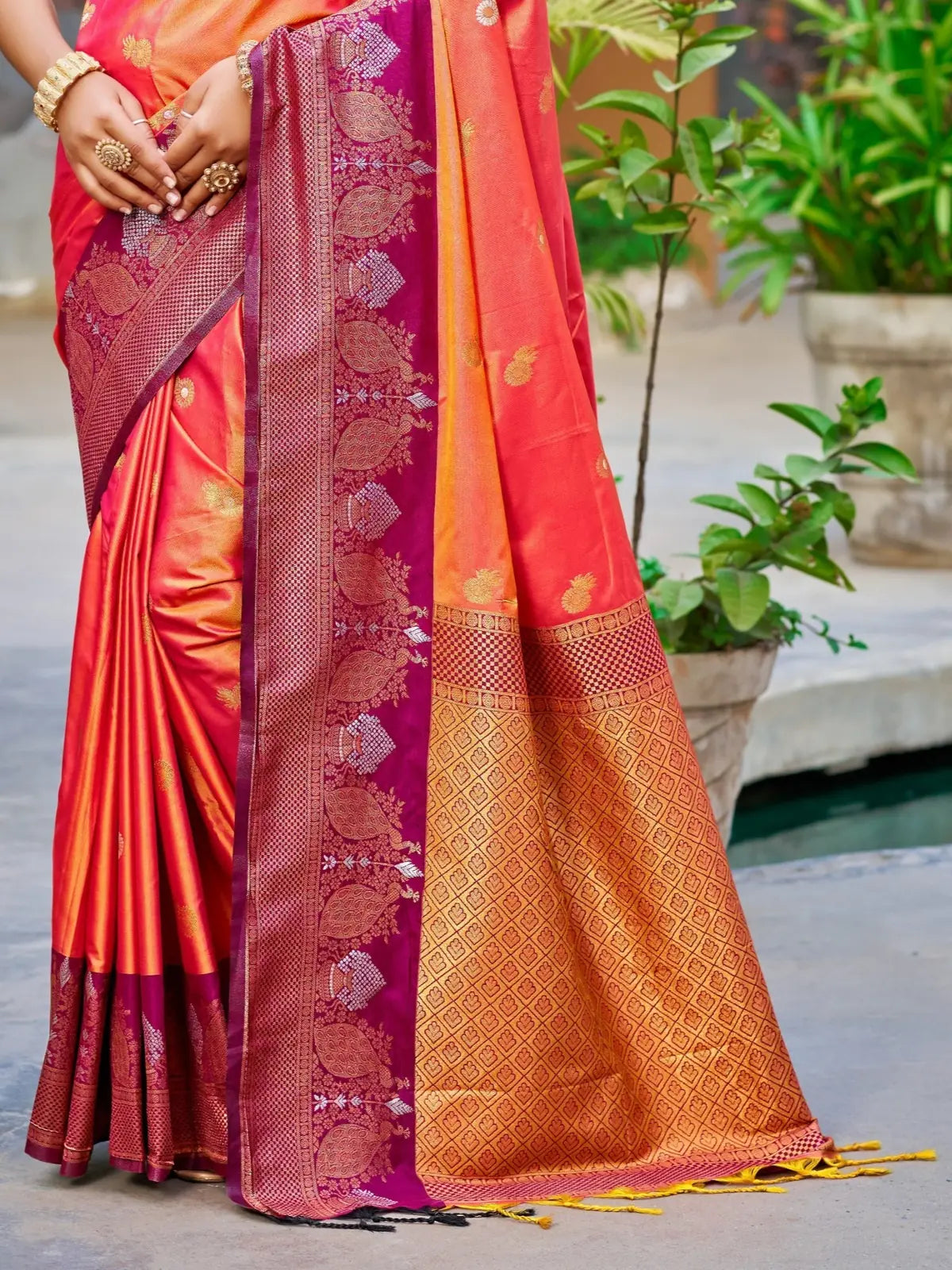 Tarani orange soft silk saree pallu view with rich woven zari border and handloom patterns