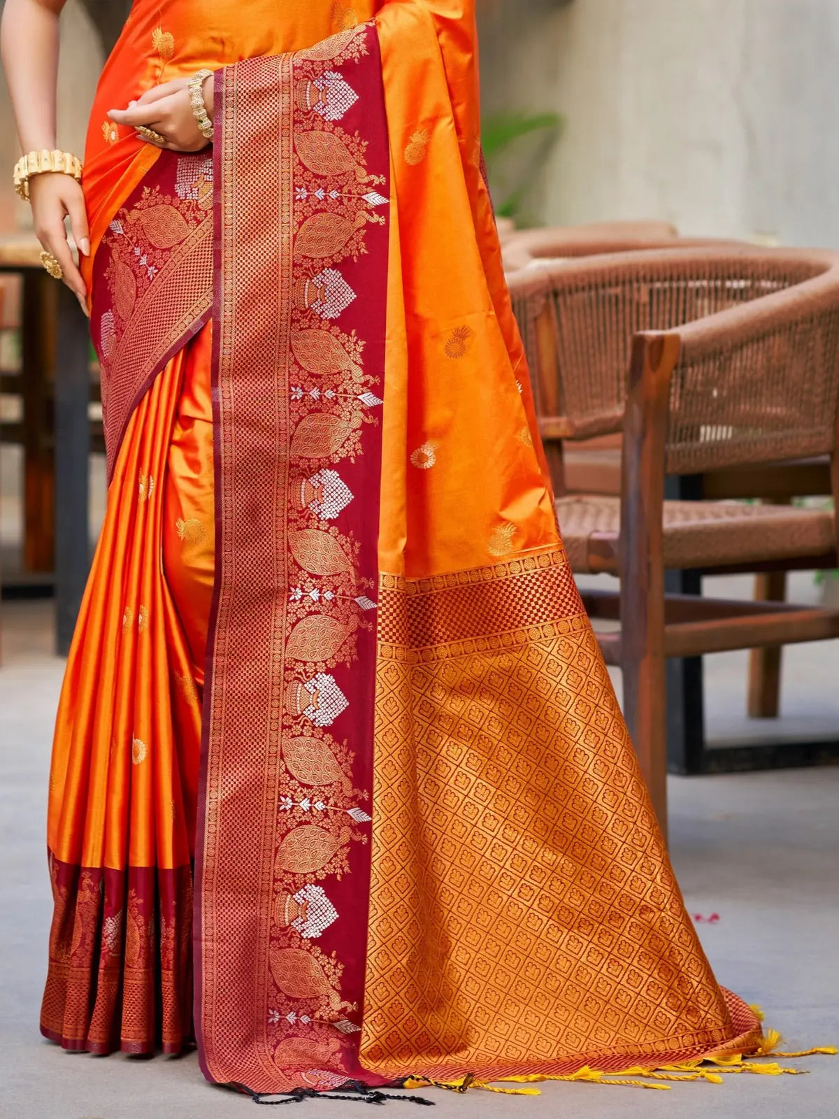 Tarani orange soft silk saree pallu view with rich woven border and handloom zari work