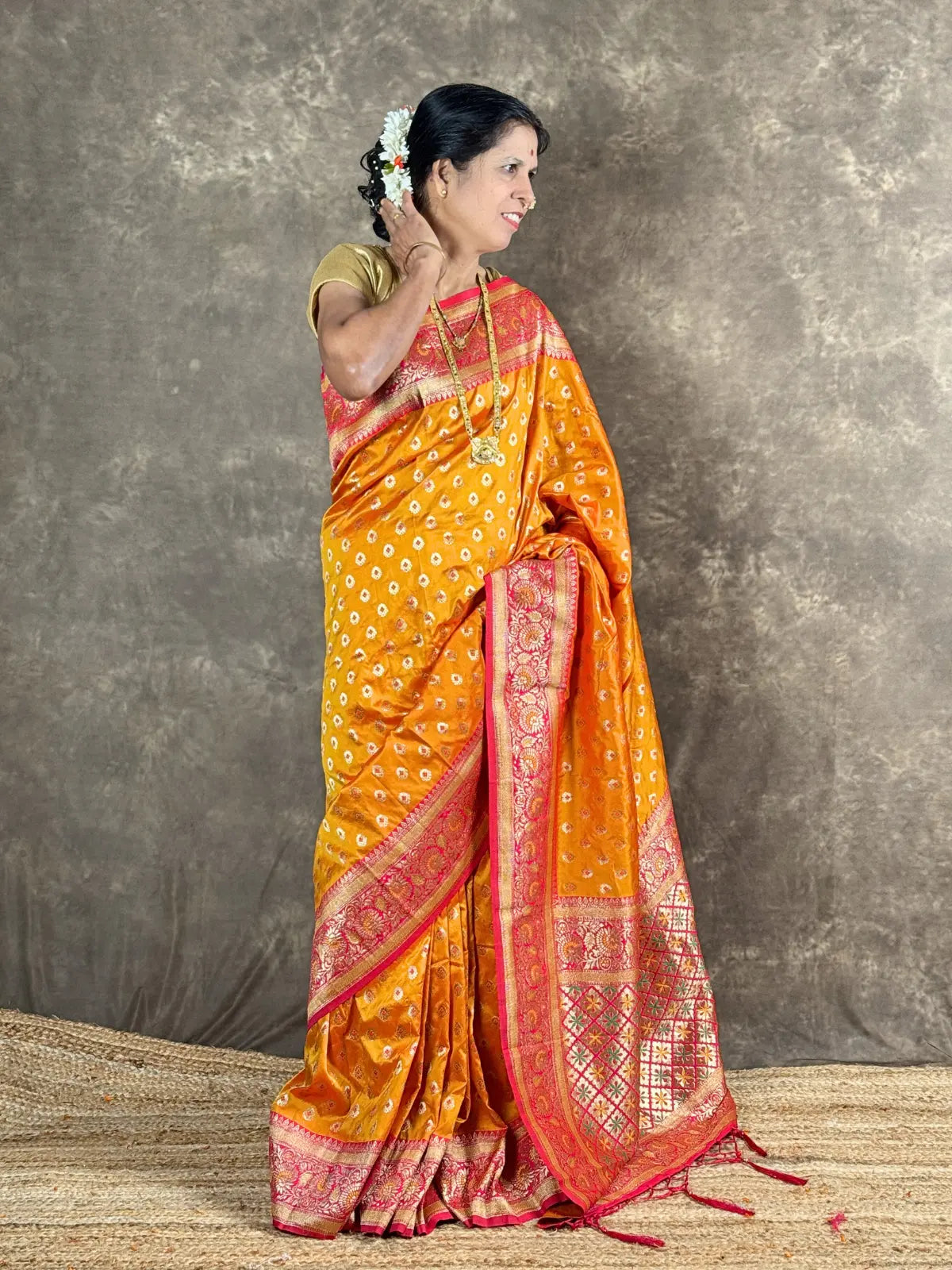 Tarani premium orange silk saree full view with woven zari border for festive occasions