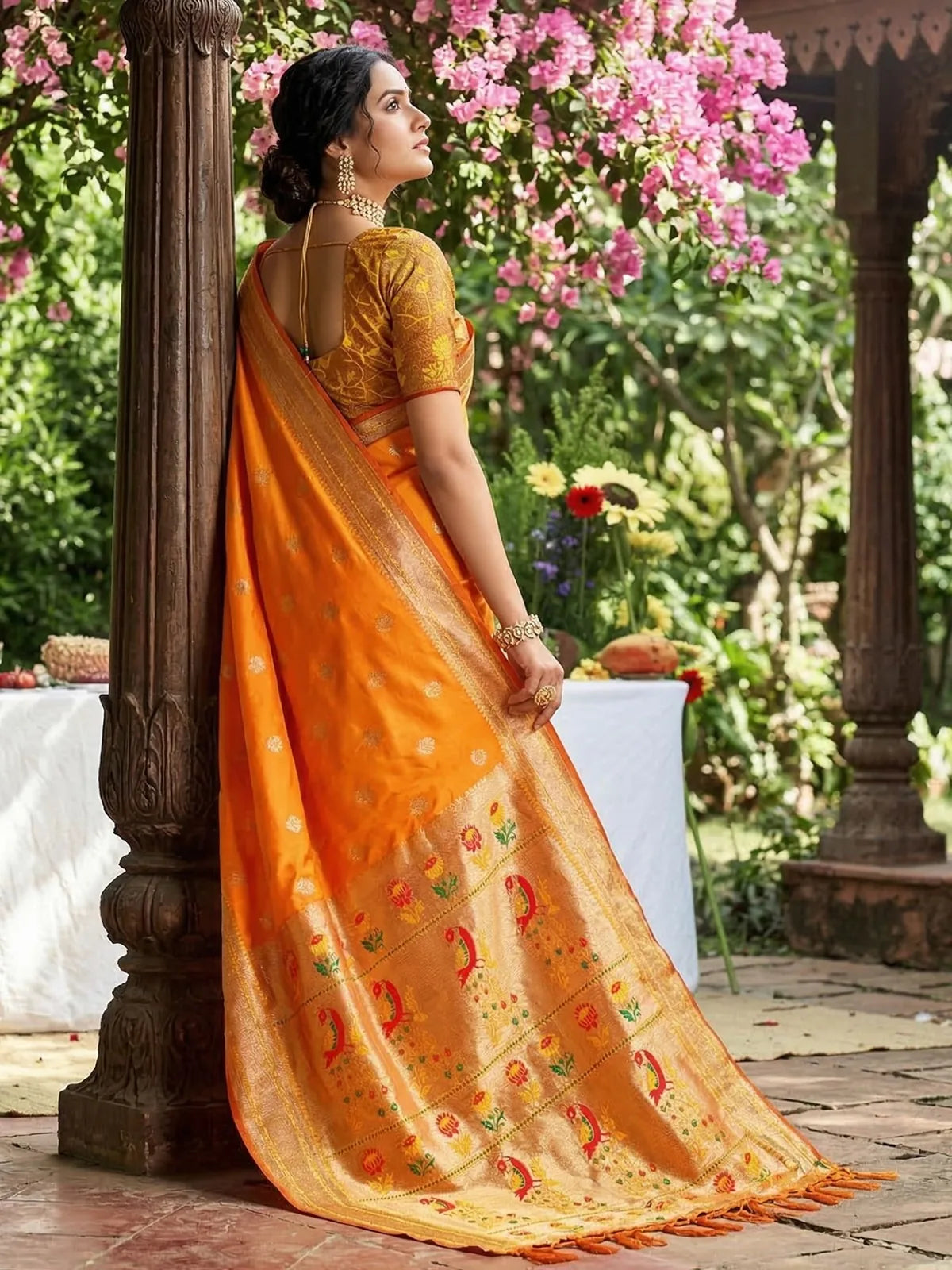 Tarani Minal orange soft silk saree side view with decorative zari pallu