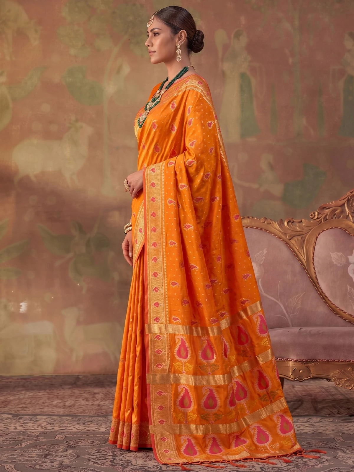 Tarani orange silk saree side view with elegant zari woven border and pallu
