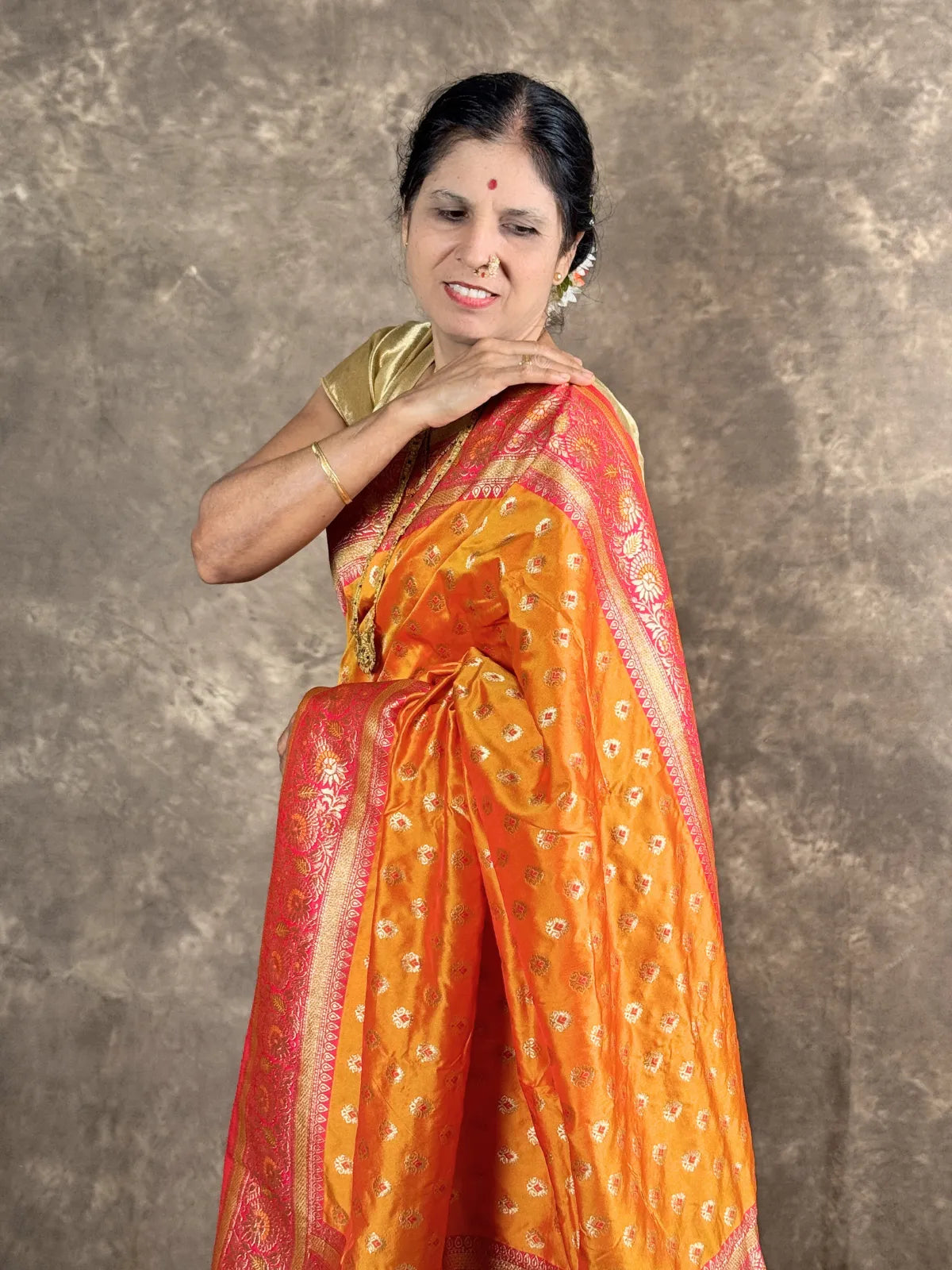 Tarani premium orange silk saree upper body view highlighting blouse and zari work