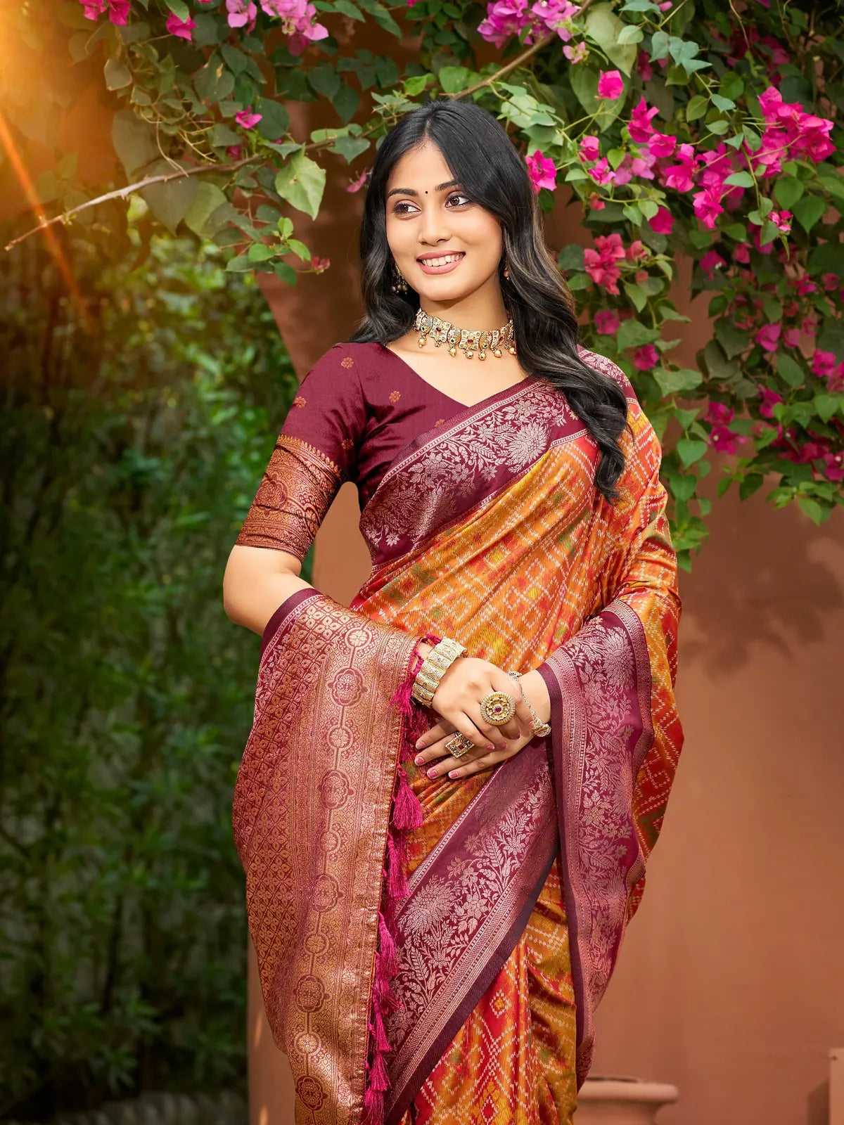 Tarani soft silk orange saree upper body view with woven maroon pallu and blouse detailing
