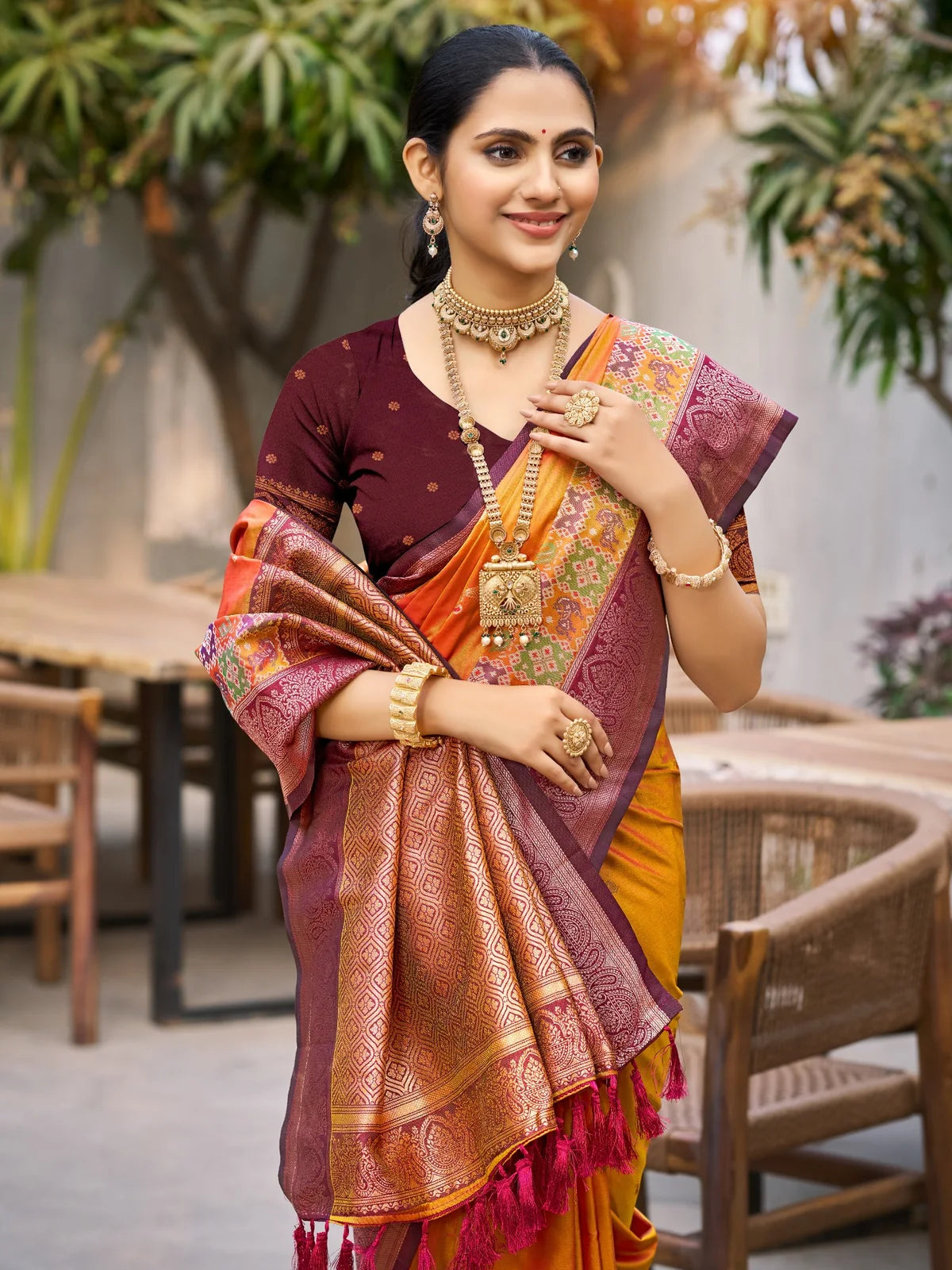 Tarani orange soft silk saree upper body view with woven contrast border and zari detailing