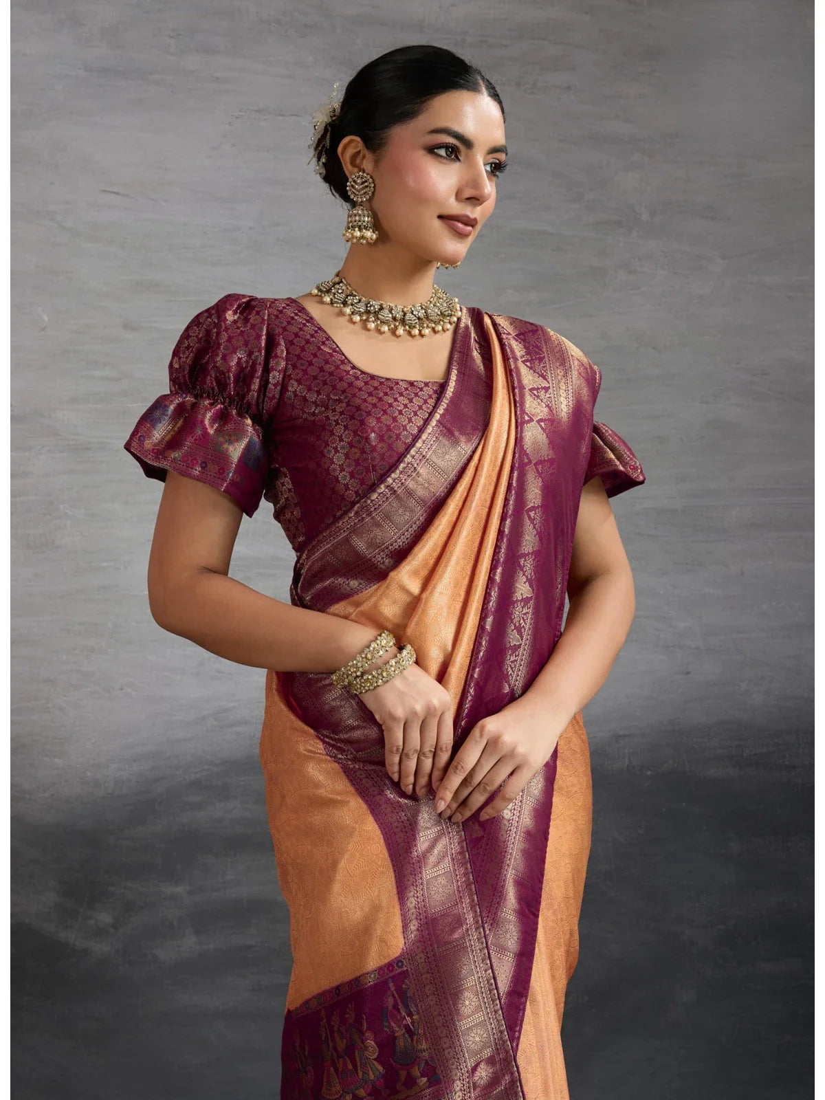 Tarani soft silk orange saree with maroon brocade blouse and puff sleeves close view