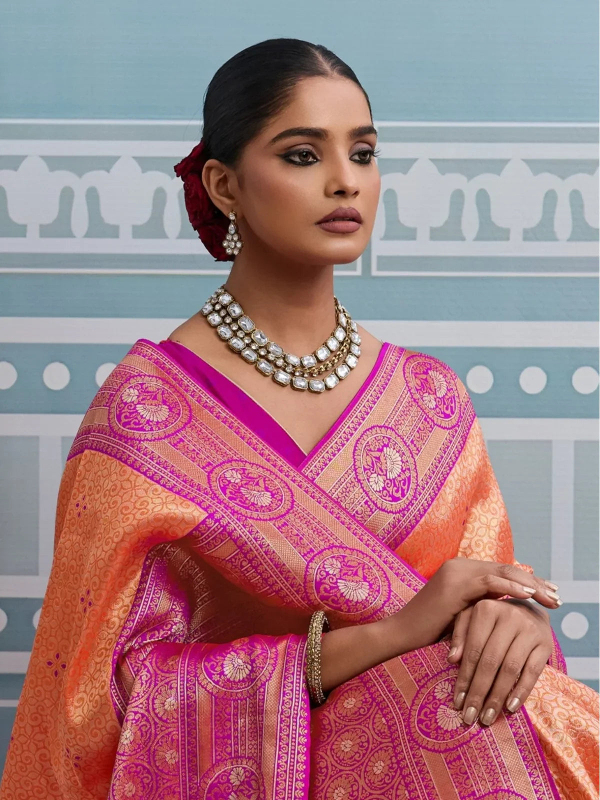 Tarani orange silk saree with intricate zari border and matching blouse upper body view