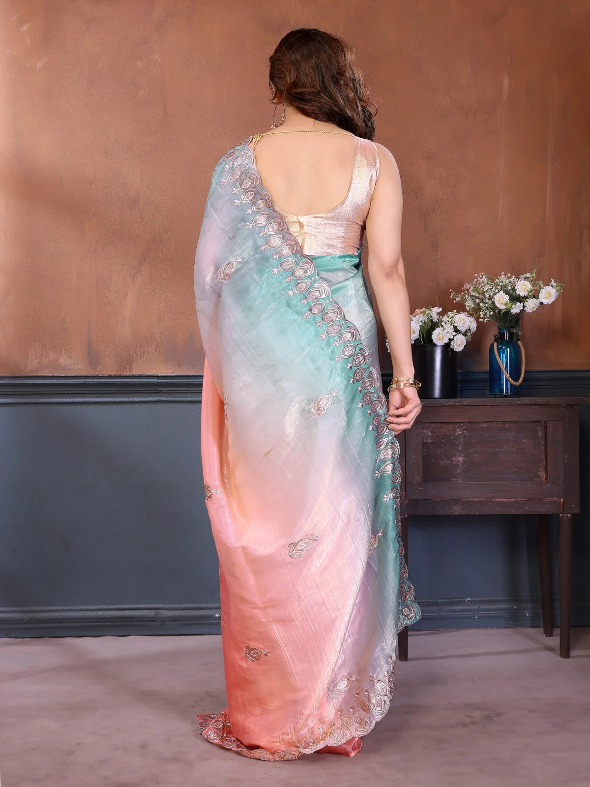 Tarani back view showing pastel shades of peach and mint in gradient silk saree