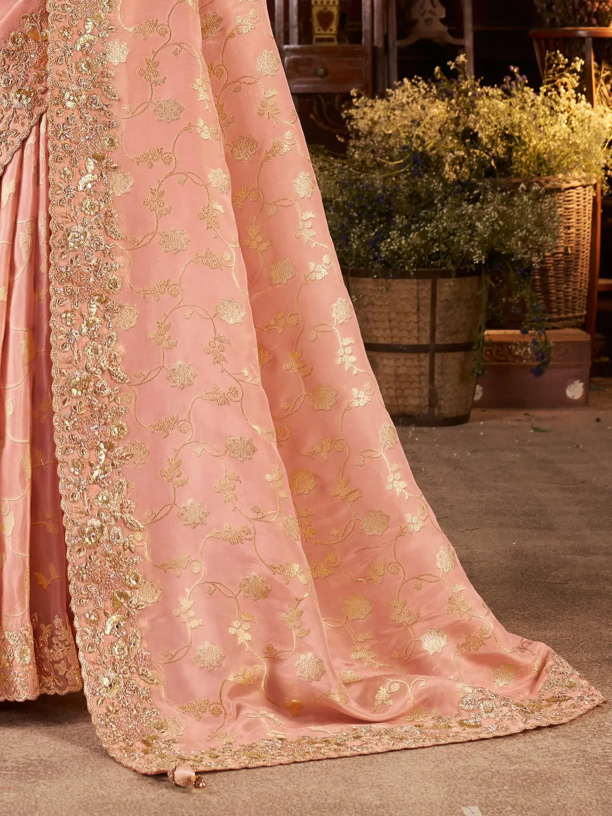 Tarani peach silk saree with focus on intricate golden zari pallu and festive border design