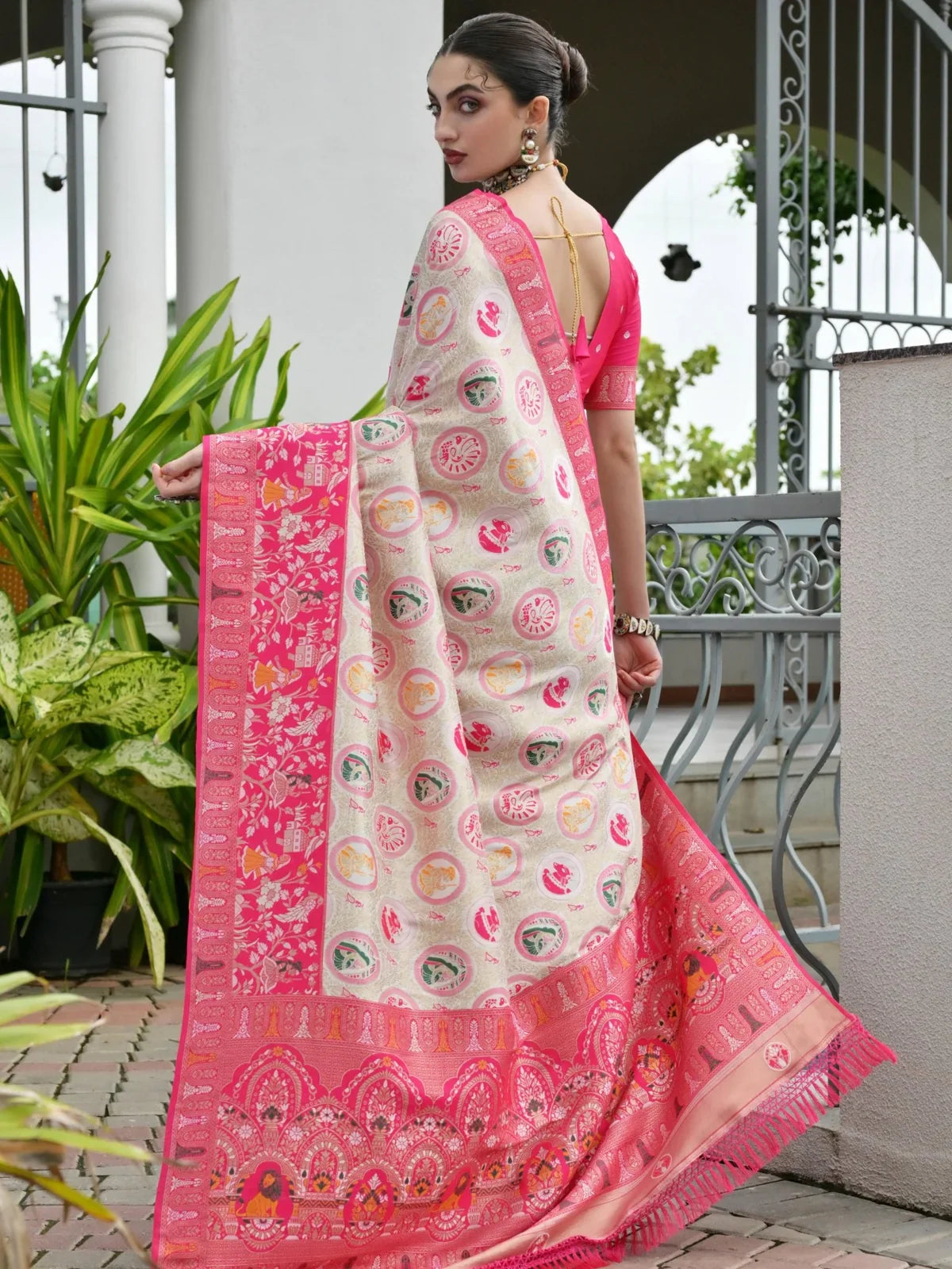 Back view of Tarani pink silk saree with contrast design and tassel blouse detail