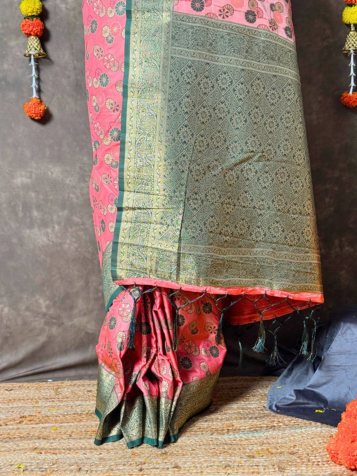 Tarani pink silk saree closeup view with intricate golden woven detailing