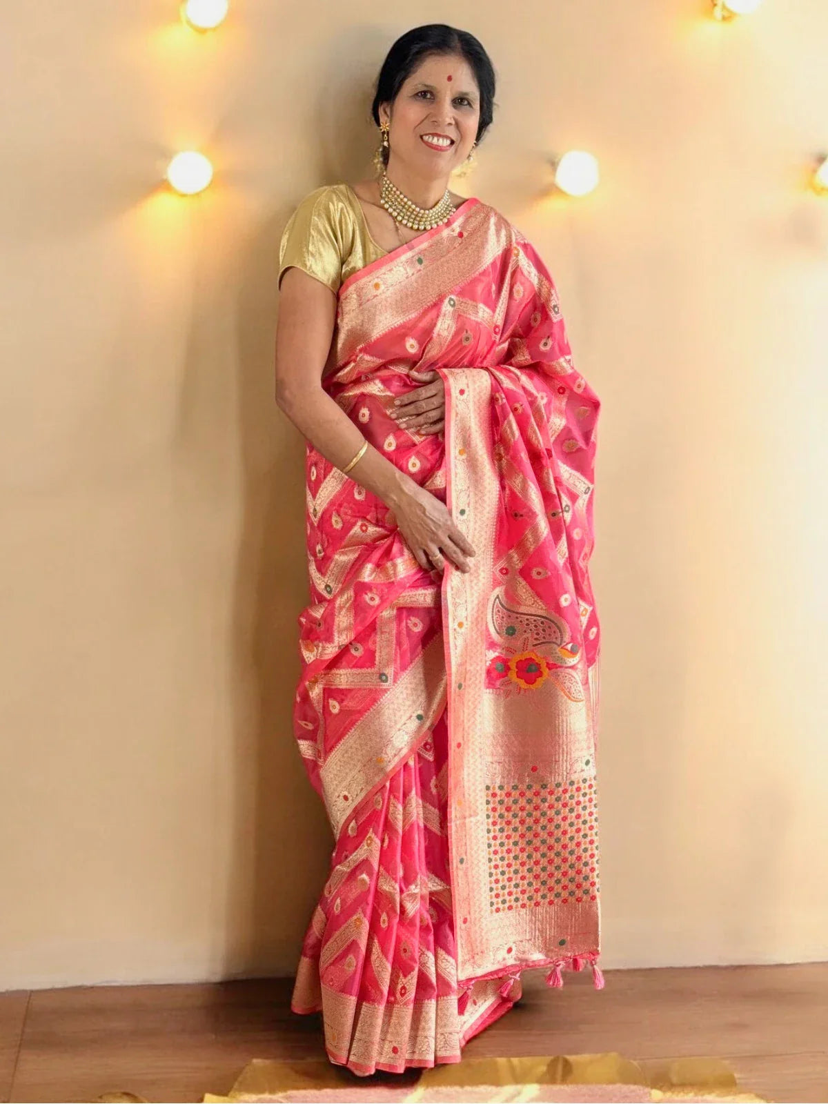 Tarani pink silk saree side pose showing intricate zari work and rich drape