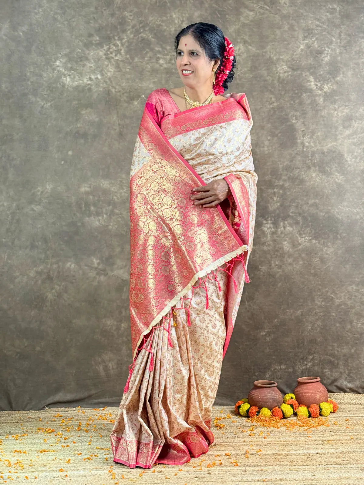 Tarani off white silk saree with pink border front view for traditional occasions