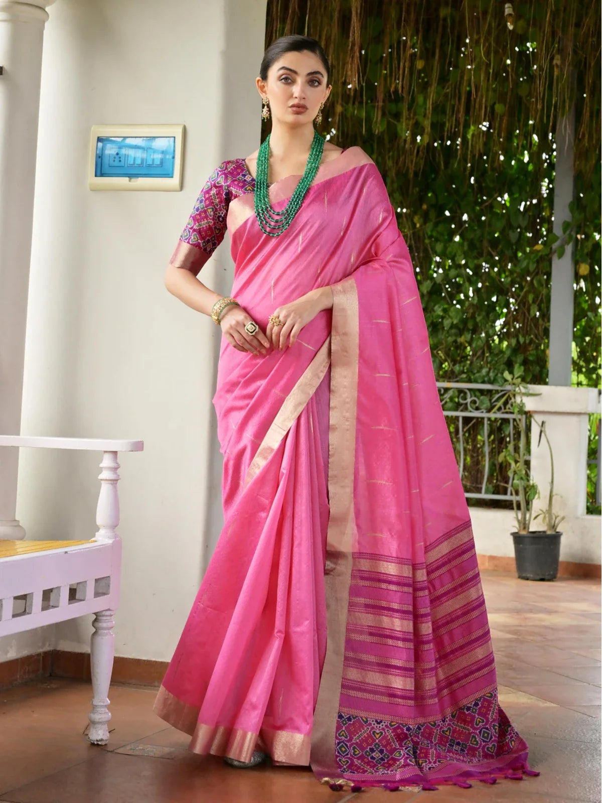 Tarani pink silk saree full view with traditional zari border and ikkat weave, styled with contrast blouse
