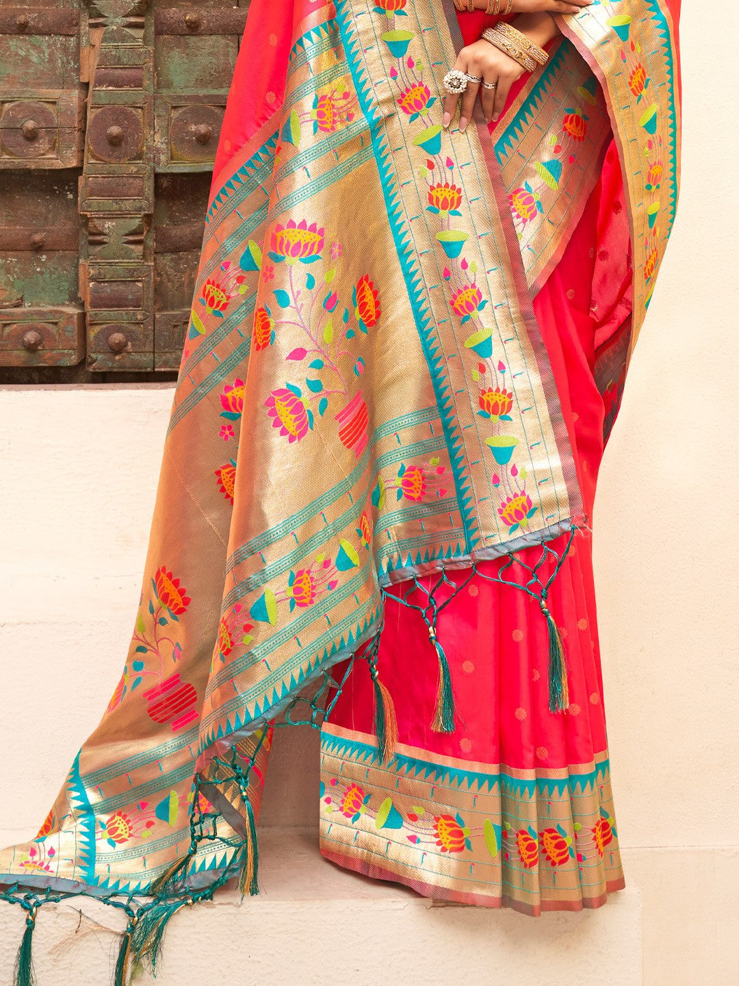 Tarani pink Paithani silk saree close pallu view showcasing zari weaving and colorful motifs