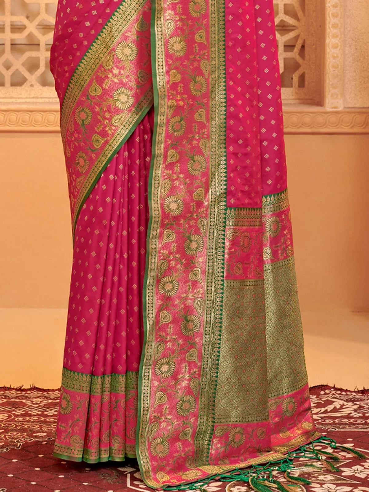 Tarani pink silk saree pallu view showing intricate weaving and golden border detailing
