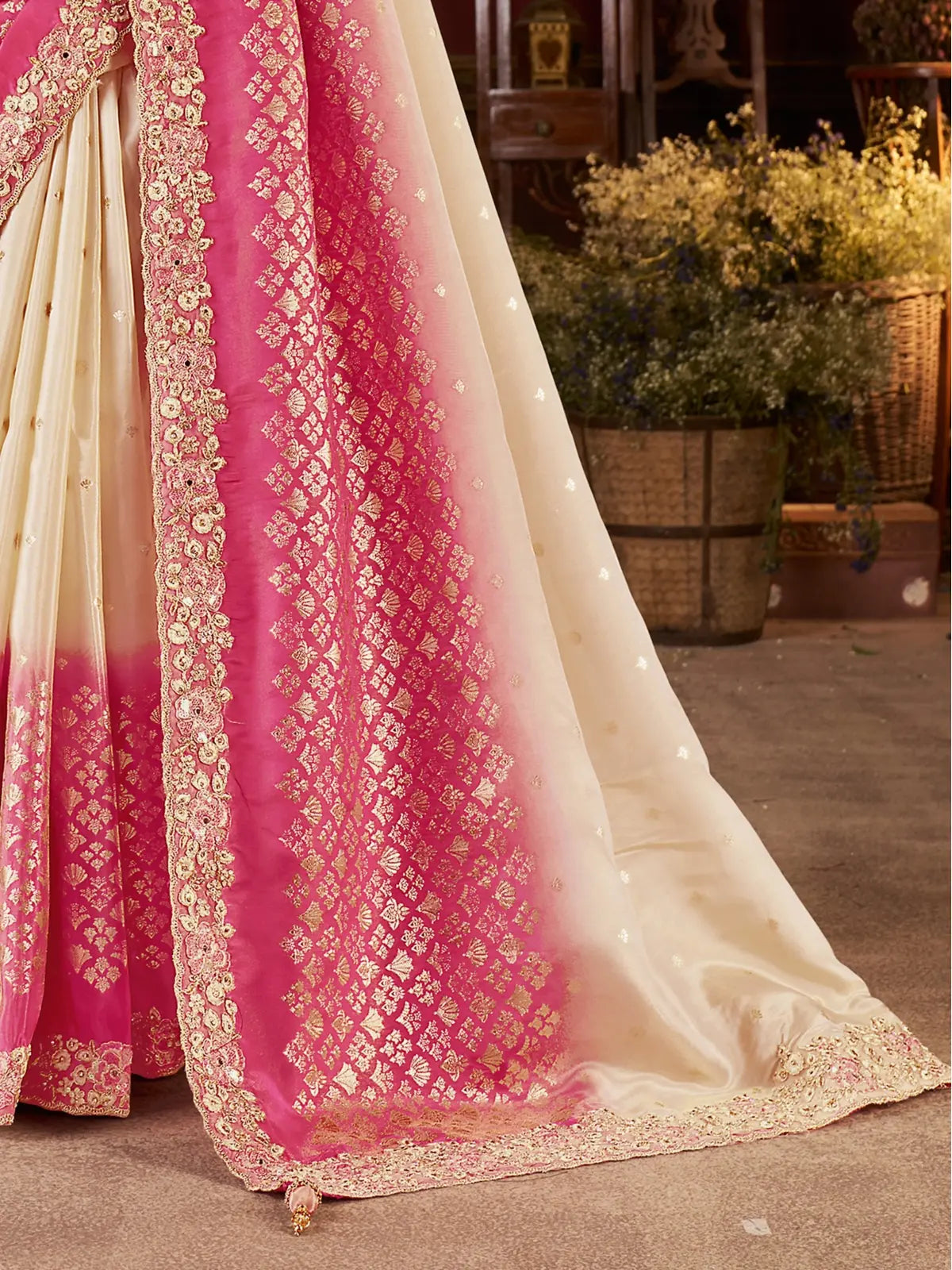 Tarani pallu and lower half view of premium pink silk saree with zari motifs and latkan detail