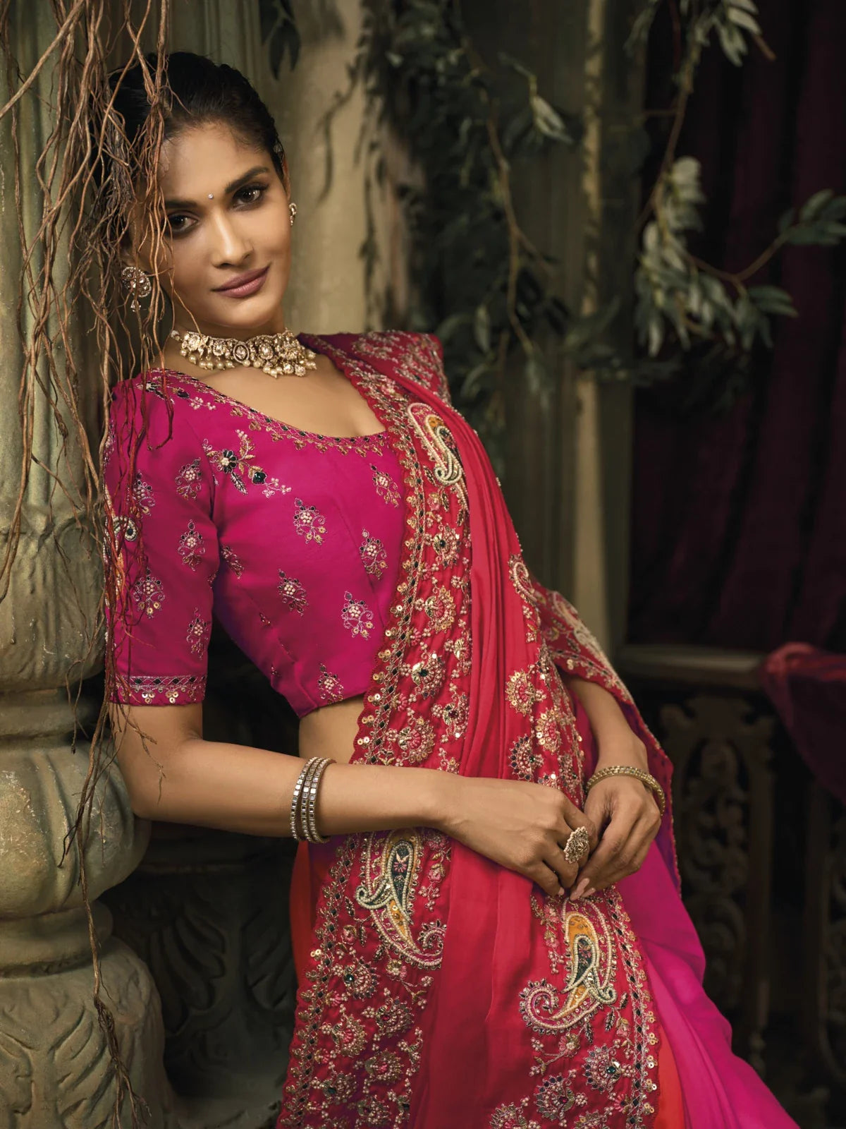 Tarani pink silk saree with emerald heavy embroidery shown in upper body view with designer blouse
