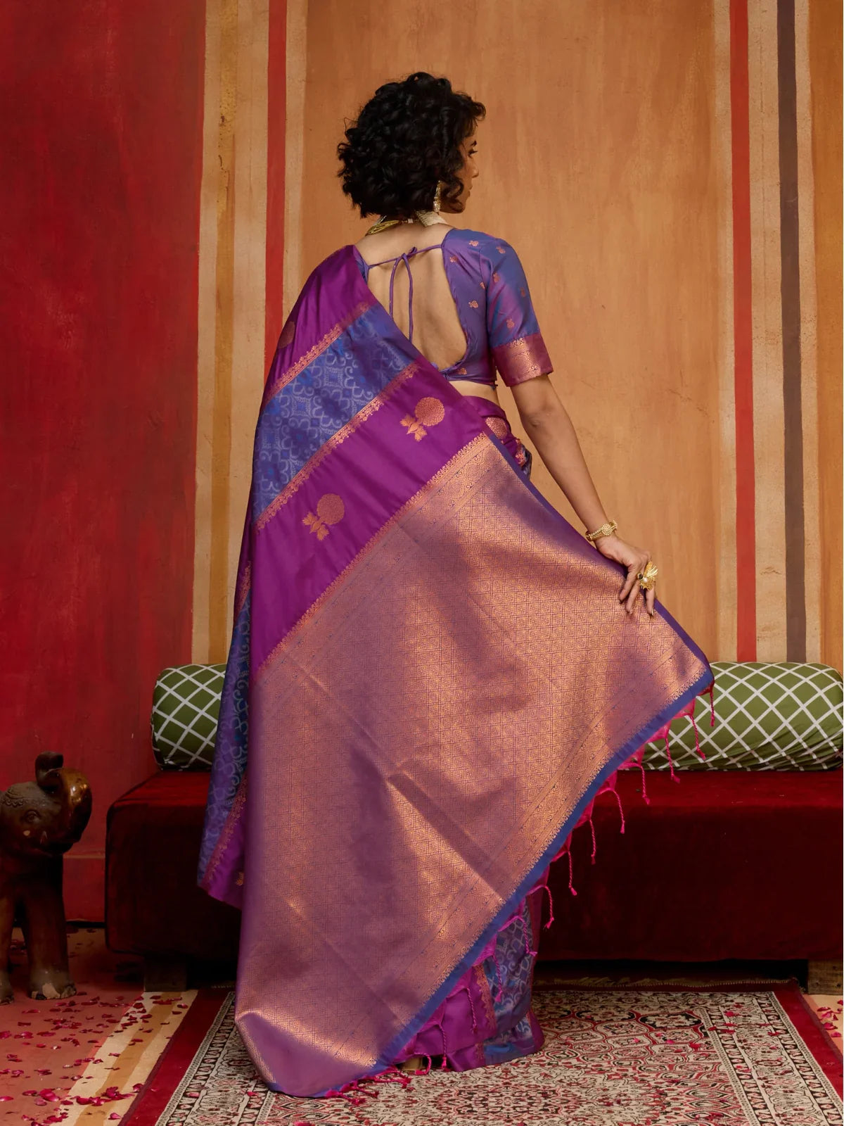 Tarani back pose showing open back blouse design with contrast pallu in purple silk saree