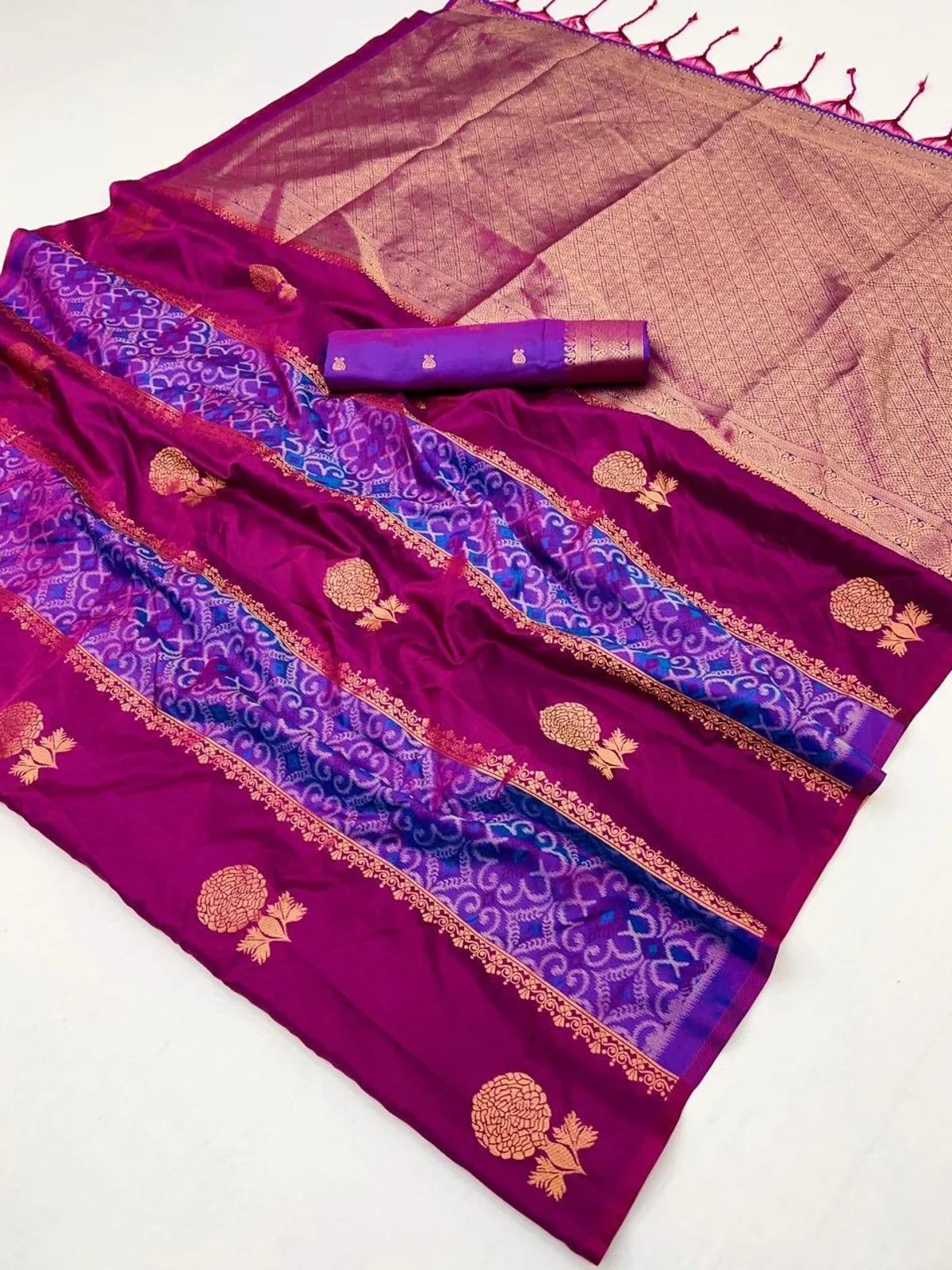 Tarani closeup of fabric texture and golden motifs on purple silk handloom saree