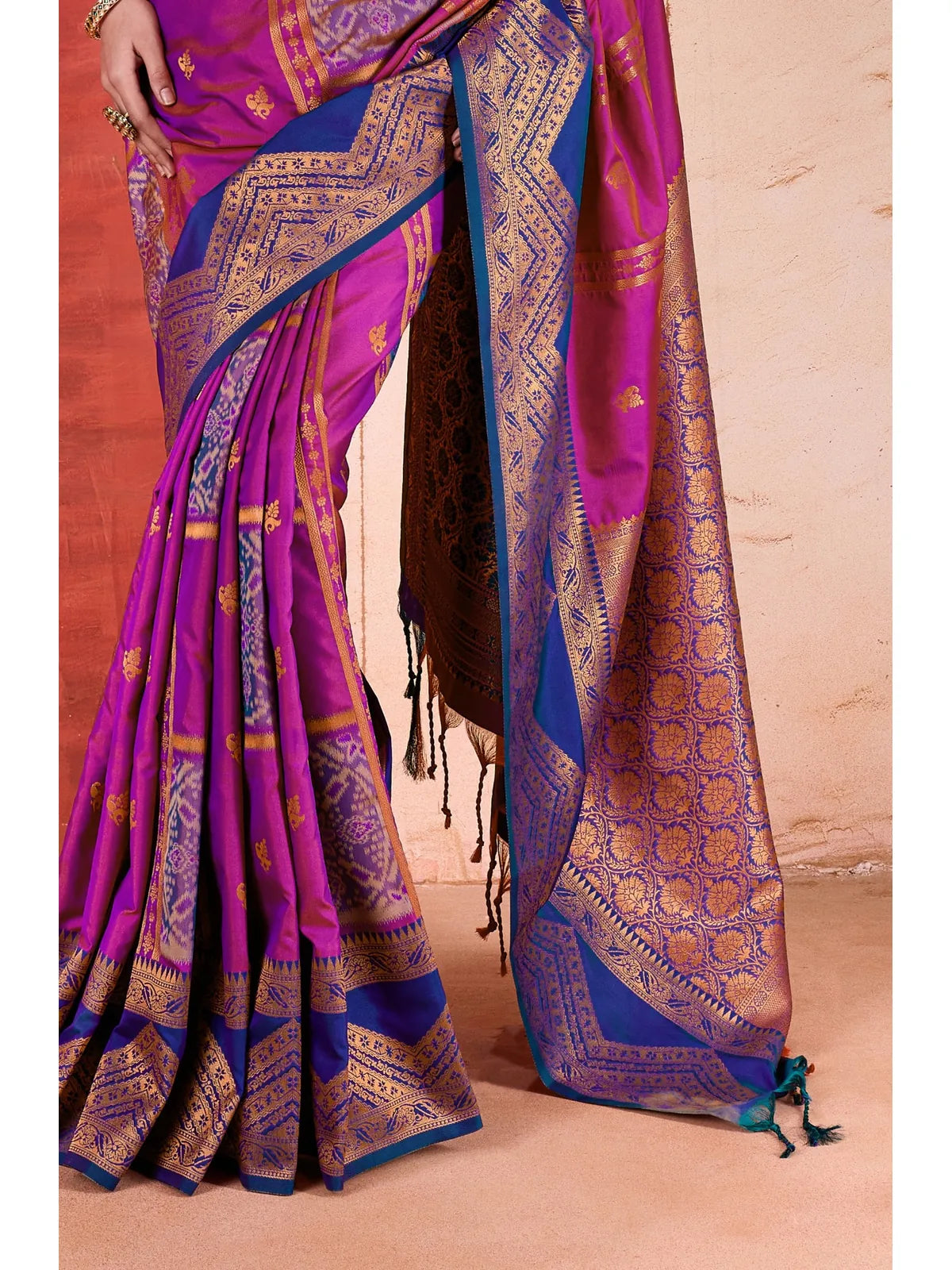 Tarani purple silk saree closeup showing golden zari motifs and weaving details